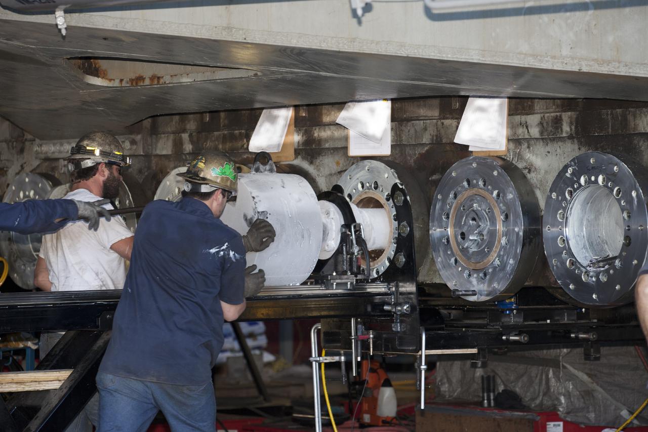 CAPE CANAVERAL, Fla. -- Technicians install a new bearing on crawler-transporter 2 in the Vehicle Assembly Building High Bay 2 at NASA's Kennedy Space Center in Florida.      Modifications underway on the crawler are designed to ensure its ability to transport launch vehicles currently under development, such as the agency’s Space Launch System, to the launch pad. Present modifications represent a redesign and upgrade to the roller bearings and assemblies originally installed on the crawler. The Ground Systems Development and Operations Program office at Kennedy is overseeing the upgrades. For more than 45 years the crawler-transporters were used to transport the mobile launcher platform carrying the Apollo-Saturn V rockets and space shuttles to Launch Pads 39A and 39B. For more information, visit http://www.nasa.gov/exploration/systems/ground/crawler-transporter_bearings_prt.htm. Photo credit: NASA/Kim Shiflett