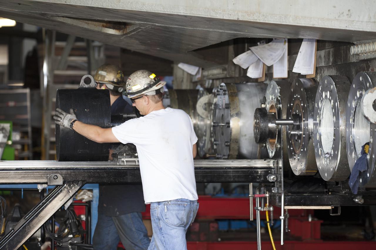 CAPE CANAVERAL, Fla. -- Technicians complete the installation of a new bearing on crawler-transporter 2 in Vehicle Assembly Building High Bay 2 at NASA's Kennedy Space Center in Florida.      Modifications underway on the crawler are designed to ensure its ability to transport launch vehicles currently under development, such as the agency’s Space Launch System, to the launch pad. Present modifications represent a redesign and upgrade to the roller bearings and assemblies originally installed on the crawler. The Ground Systems Development and Operations Program office at Kennedy is overseeing the upgrades. For more than 45 years the crawler-transporters were used to transport the mobile launcher platform carrying the Apollo-Saturn V rockets and space shuttles to Launch Pads 39A and 39B. For more information, visit http://www.nasa.gov/exploration/systems/ground/crawler-transporter_bearings_prt.htm. Photo credit: NASA/Kim Shiflett