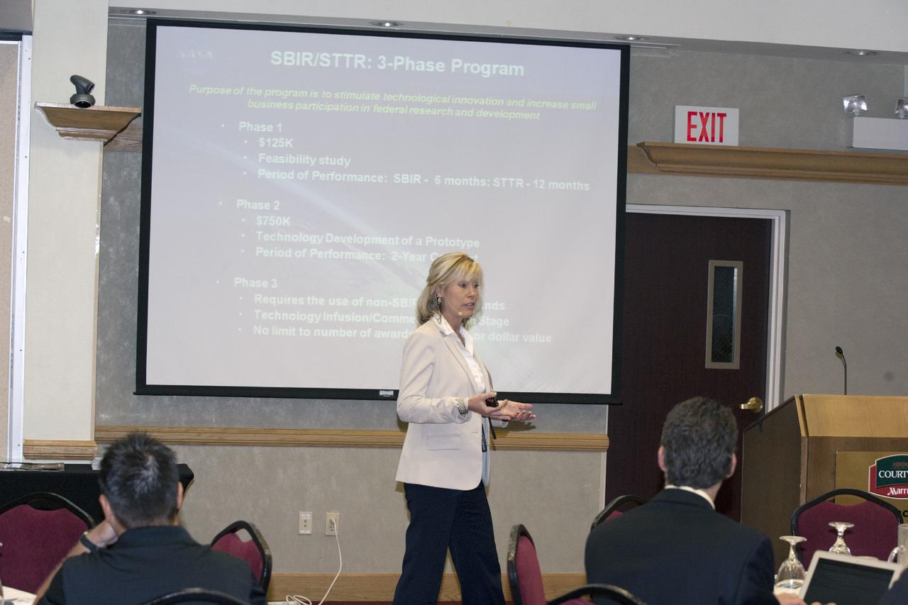 CAPE CANAVERAL, Fla. – Joni Richards, Technology Infusion specialist at NASA's Kennedy Space Center in Florida, discusses technology transfer with attendees at the Technology Transfer Forum of the Economic Development Commission of Florida's Space Coast. A goal of the session was to showcase ways commercial businesses can work with NASA to develop technology and apply existing technology to commercial uses. Photo credit: NASA/Glenn Benson