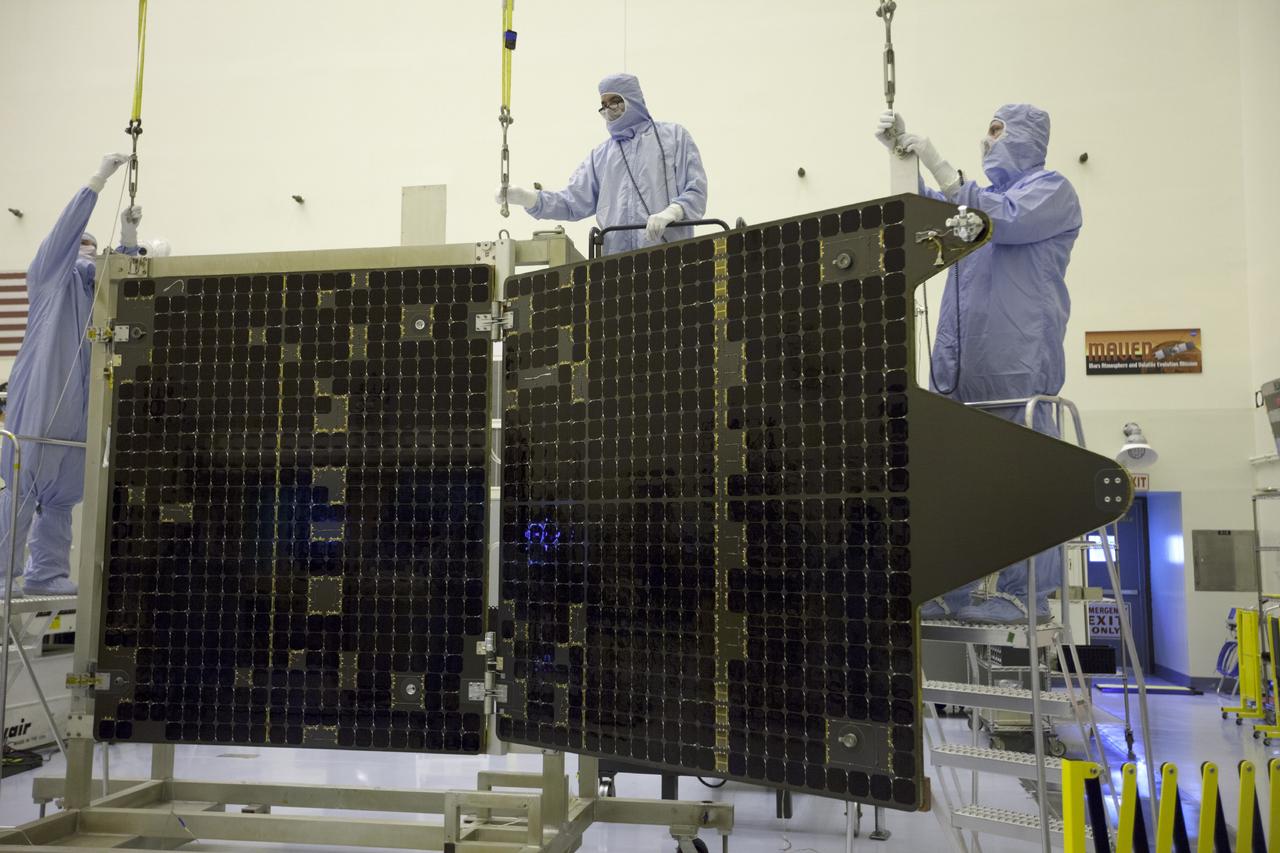 CAPE CANAVERAL, Fla. – Inside the Payload Hazardous Servicing Facility at NASA's Kennedy Space Center in Florida, engineers and technicians prepare to reattach twin solar arrays to the Mars Atmosphere and Volatile Evolution, or MAVEN, spacecraft following inspection and testing.      MAVEN is being prepared for its scheduled launch in November from Cape Canaveral Air Force Station, Fla. atop a United Launch Alliance Atlas V rocket. Positioned in an orbit above the Red Planet, MAVEN will study the upper atmosphere of Mars in unprecedented detail. For more information, visit: http://www.nasa.gov/mission_pages/maven/main/index.html Photo credit: NASA/Kim Shiflett