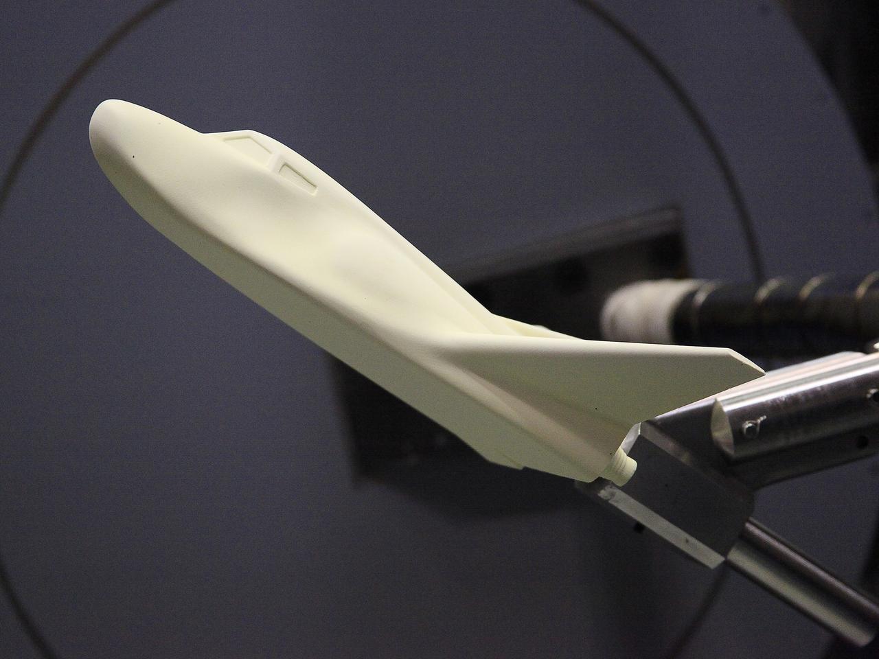 HAMPTON, Va. –A 10-inch long ceramic model of the Sierra Nevada Corporation, or SNC, Dream Chaser spacecraft is prepared for high-speed wind tunnel tests at NASA's Langley Research Center in Hampton, Va. The tests measure how much heat the winged vehicle would experience during ascent and re-entry through the atmosphere, including the spacecraft's lower- and upper-body flaps, elevons and a rudder. They're also helping the company obtain necessary data for the material selection and design of the spacecraft's thermal protection system.      SNC is continuing the development of its Dream Chaser spacecraft under the agency's Commercial Crew Integrated Capability, or CCiCap, initiative, which is intended to lead to the availability of commercial human spaceflight services for government and commercial customers. To learn more about CCP and its industry partners, visit www.nasa.gov/commercialcrew. Image credit: NASA/David Bowman