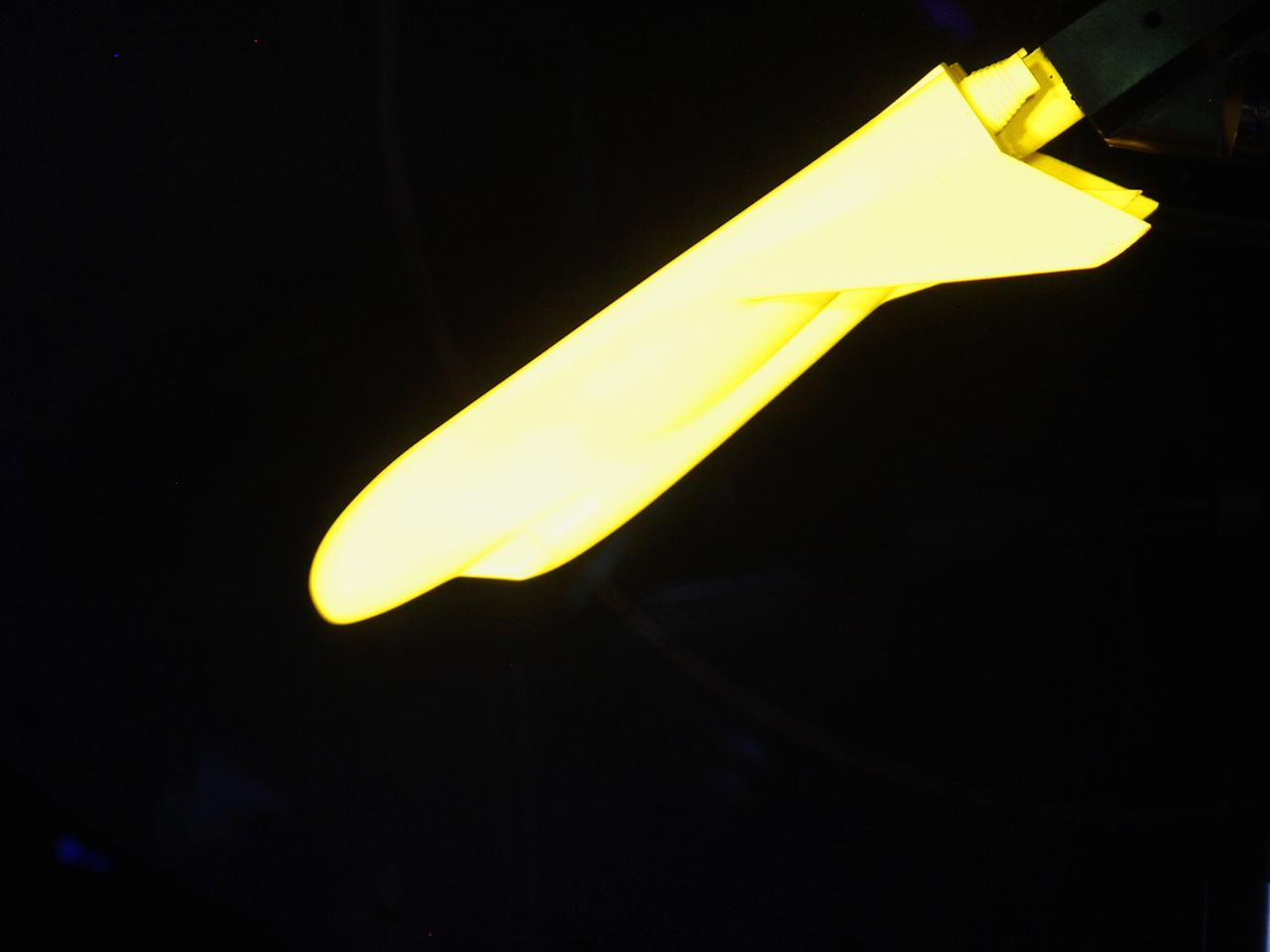 HAMPTON, Va. –A 10-inch long ceramic model of the Sierra Nevada Corporation, or SNC, Dream Chaser spacecraft undergoes high-speed wind tunnel tests at NASA's Langley Research Center in Hampton, Va. The tests measure how much heat the winged vehicle would experience during ascent and re-entry through the atmosphere, including the spacecraft's lower- and upper-body flaps, elevons and a rudder. They're also helping the company obtain necessary data for the material selection and design of the spacecraft's thermal protection system.      SNC is continuing the development of its Dream Chaser spacecraft under the agency's Commercial Crew Integrated Capability, or CCiCap, initiative, which is intended to lead to the availability of commercial human spaceflight services for government and commercial customers. To learn more about CCP and its industry partners, visit www.nasa.gov/commercialcrew. Image credit: NASA/David Bowman