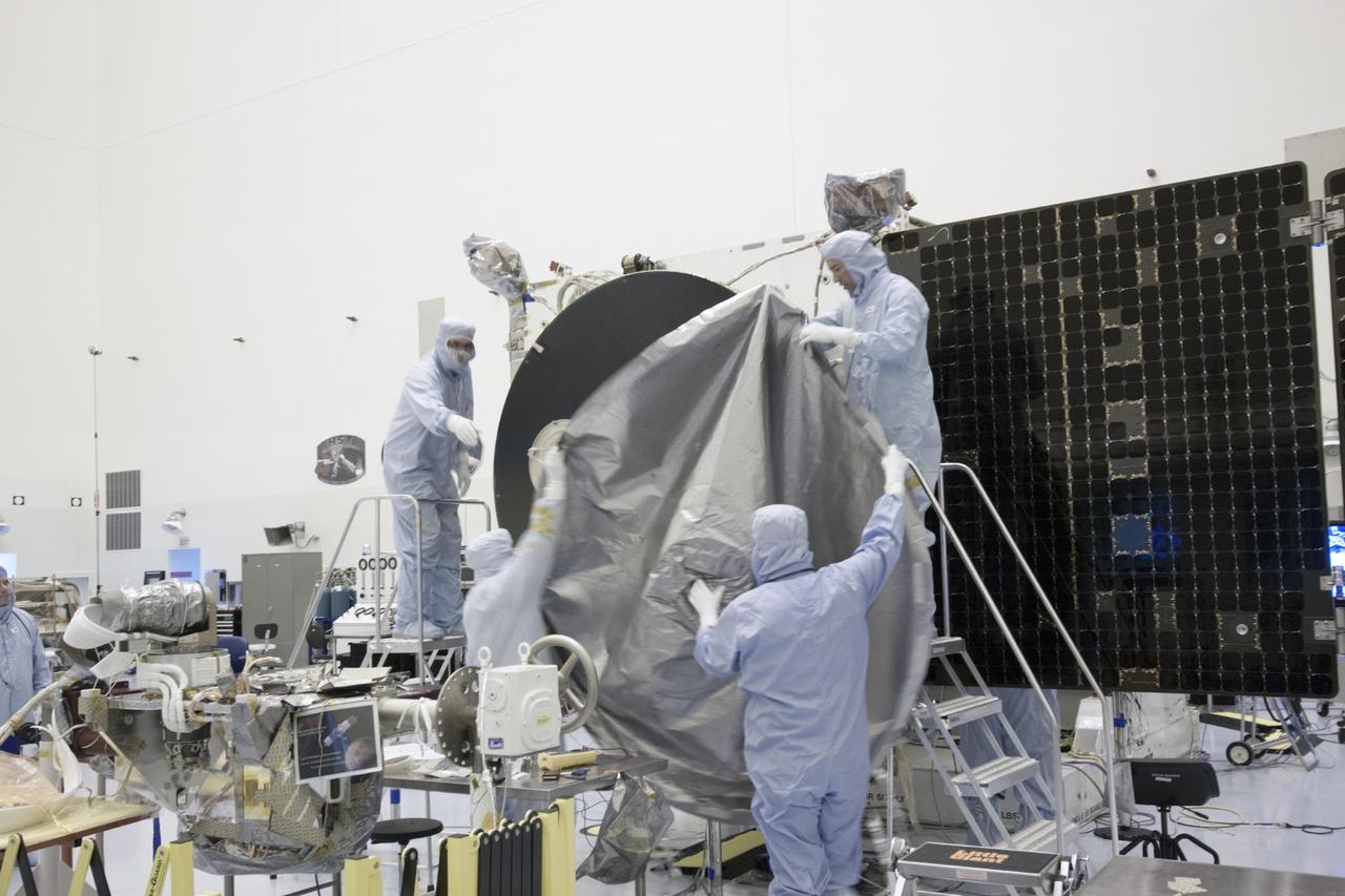 CAPE CANAVERAL, Fla. – Inside the Payload Hazardous Servicing Facility at NASA's Kennedy Space Center in Florida, engineers and technicians install a radome over the antenna for the Mars Atmosphere and Volatile Evolution, or MAVEN, spacecraft. The radome is a coated kapton cover providing thermal protection for the high gain antenna while not interfering with radio frequency transmissions from the spacecraft.      MAVEN is being prepared for its scheduled launch in November from Cape Canaveral Air Force Station, Fla. atop a United Launch Alliance Atlas V rocket. Positioned in an orbit above the Red Planet, MAVEN will study the upper atmosphere of Mars in unprecedented detail. For more information, visit: http://www.nasa.gov/mission_pages/maven/main/index.html Photo credit: NASA/Jim Grossmann
