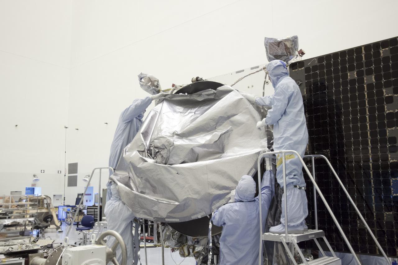 CAPE CANAVERAL, Fla. – Inside the Payload Hazardous Servicing Facility at NASA's Kennedy Space Center in Florida, engineers and technicians install a radome over the antenna for the Mars Atmosphere and Volatile Evolution, or MAVEN, spacecraft. The radome is a coated kapton cover providing thermal protection for the high gain antenna while not interfering with radio frequency transmissions from the spacecraft.    MAVEN is being prepared for its scheduled launch in November from Cape Canaveral Air Force Station, Fla. atop a United Launch Alliance Atlas V rocket. Positioned in an orbit above the Red Planet, MAVEN will study the upper atmosphere of Mars in unprecedented detail. For more information, visit: http://www.nasa.gov/mission_pages/maven/main/index.html Photo credit: NASA/Jim Grossmann