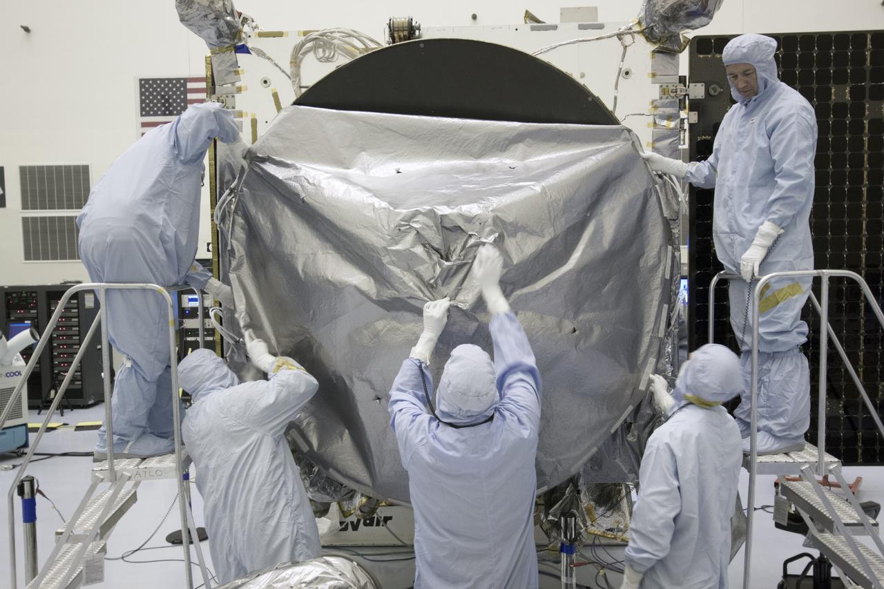CAPE CANAVERAL, Fla. – Inside the Payload Hazardous Servicing Facility at NASA's Kennedy Space Center in Florida, engineers and technicians install a radome over the antenna for the Mars Atmosphere and Volatile Evolution, or MAVEN, spacecraft. The radome is a coated kapton cover providing thermal protection for the high gain antenna while not interfering with radio frequency transmissions from the spacecraft.      MAVEN is being prepared for its scheduled launch in November from Cape Canaveral Air Force Station, Fla. atop a United Launch Alliance Atlas V rocket. Positioned in an orbit above the Red Planet, MAVEN will study the upper atmosphere of Mars in unprecedented detail. For more information, visit: http://www.nasa.gov/mission_pages/maven/main/index.html Photo credit: NASA/Jim Grossmann