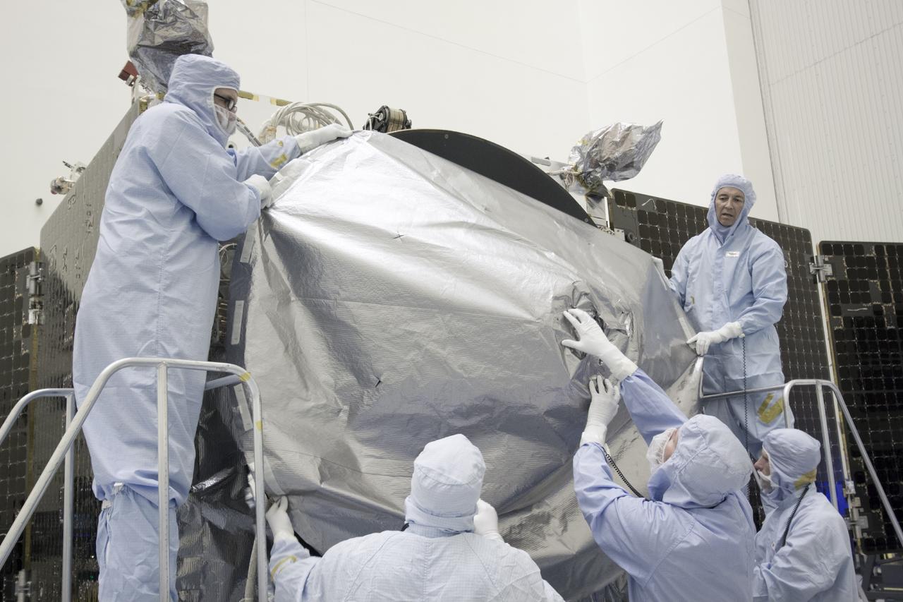 CAPE CANAVERAL, Fla. – Inside the Payload Hazardous Servicing Facility at NASA's Kennedy Space Center in Florida, engineers and technicians install a radome over the antenna for the Mars Atmosphere and Volatile Evolution, or MAVEN, spacecraft. The radome is a coated kapton cover providing thermal protection for the high gain antenna while not interfering with radio frequency transmissions from the spacecraft.      MAVEN is being prepared for its scheduled launch in November from Cape Canaveral Air Force Station, Fla. atop a United Launch Alliance Atlas V rocket. Positioned in an orbit above the Red Planet, MAVEN will study the upper atmosphere of Mars in unprecedented detail. For more information, visit: http://www.nasa.gov/mission_pages/maven/main/index.html Photo credit: NASA/Jim Grossmann