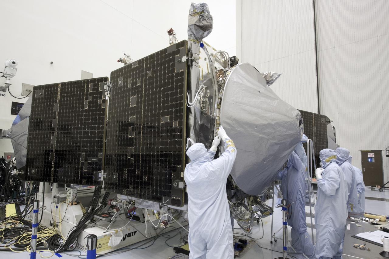 CAPE CANAVERAL, Fla. – Inside the Payload Hazardous Servicing Facility at NASA's Kennedy Space Center in Florida, engineers and technicians install a radome over the antenna for the Mars Atmosphere and Volatile Evolution, or MAVEN, spacecraft. The radome is a coated kapton cover providing thermal protection for the high gain antenna while not interfering with radio frequency transmissions from the spacecraft.        MAVEN is being prepared for its scheduled launch in November from Cape Canaveral Air Force Station, Fla. atop a United Launch Alliance Atlas V rocket. Positioned in an orbit above the Red Planet, MAVEN will study the upper atmosphere of Mars in unprecedented detail. For more information, visit: http://www.nasa.gov/mission_pages/maven/main/index.html Photo credit: NASA/Jim Grossmann