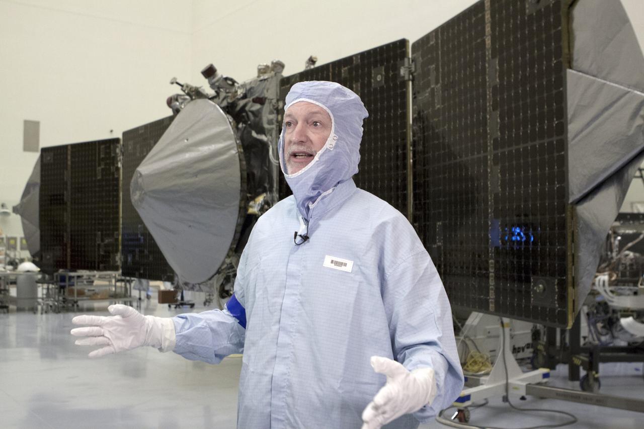 CAPE CANAVERAL, Fla. – The University of Colorado's Bruce Jankosky, principal investigator for the Mars Atmosphere and Volatile Evolution, or MAVEN, mission, speaks to a member of the news media. Inside the Payload Hazardous Servicing Facility at the agency's Kennedy Space Center in Florida, MAVEN is going through pre-launch processing. Engineers will soon fold MAVEN's power-generating solar arrays into launch position on either side of the spacecraft's main body.      MAVEN is being prepared for its scheduled launch in November from Cape Canaveral Air Force Station, Fla. atop a United Launch Alliance Atlas V rocket. Positioned in an orbit above the Red Planet, MAVEN will study the upper atmosphere of Mars in unprecedented detail. For more information, visit: http://www.nasa.gov/mission_pages/maven/main/index.html Photo credit: NASA/Kim Shiflett