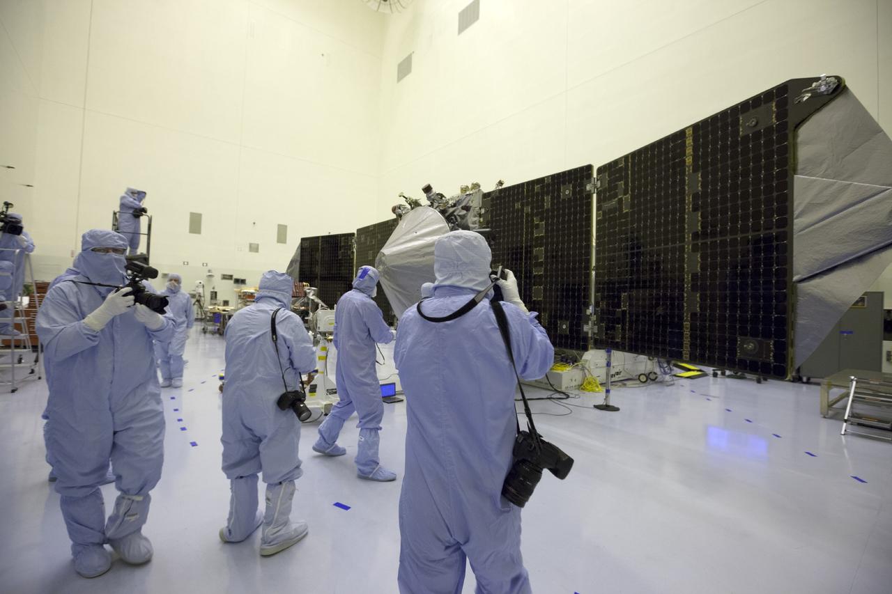 CAPE CANAVERAL, Fla. – Inside the Payload Hazardous Servicing Facility at NASA's Kennedy Space Center in Florida, reporters and photographers look over the Mars Atmosphere and Volatile Evolution, or MAVEN, spacecraft. Members of the news media were given an opportunity to view MAVEN and interview program officials.      MAVEN is being prepared for its scheduled launch in November from Cape Canaveral Air Force Station, Fla. atop a United Launch Alliance Atlas V rocket. Positioned in an orbit above the Red Planet, MAVEN will study the upper atmosphere of Mars in unprecedented detail. For more information, visit: http://www.nasa.gov/mission_pages/maven/main/index.html Photo credit: NASA/Kim Shiflett