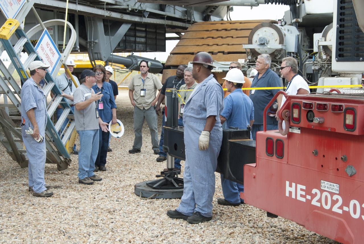 CAPE CANAVERAL, Fla. – Ground support equipment technicians review procedures before removing jacking, equalizing and leveling, or JEL, hydraulic cylinders from crawler-transporter 1 at the crawler transporter maintenance facility at NASA’s Kennedy Space Center in Florida. Sixteen new JEL hydraulic cylinders will be installed on CT-1 to increase load carrying capacity and reliability. The Ground Systems Development and Operations Program at Kennedy continues to upgrade CT-1 as part of its general maintenance. CT-1 could be available to carry commercial launch vehicles to the launch pad. The crawler-transporters were used to carry the mobile launcher platform and space shuttle to Launch Complex 39 for space shuttle launches for 30 years. Photo credit: NASA/Tim Jacobs