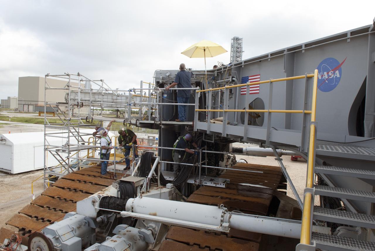 CAPE CANAVERAL, Fla. – Preparations are underway to begin removing the jacking, equalizing and leveling, or JEL, hydraulic cylinders from crawler-transporter 1 at the crawler transporter maintenance facility at NASA’s Kennedy Space Center in Florida. Sixteen new JEL hydraulic cylinders will be installed on CT-1 to increase load carrying capacity and reliability. The Ground Systems Development and Operations Program at Kennedy continues to upgrade CT-1 as part of its general maintenance. CT-1 could be available to carry commercial launch vehicles to the launch pad. The crawler-transporters were used to carry the mobile launcher platform and space shuttle to Launch Complex 39 for space shuttle launches for 30 years. Photo credit: NASA/Tim Jacobs