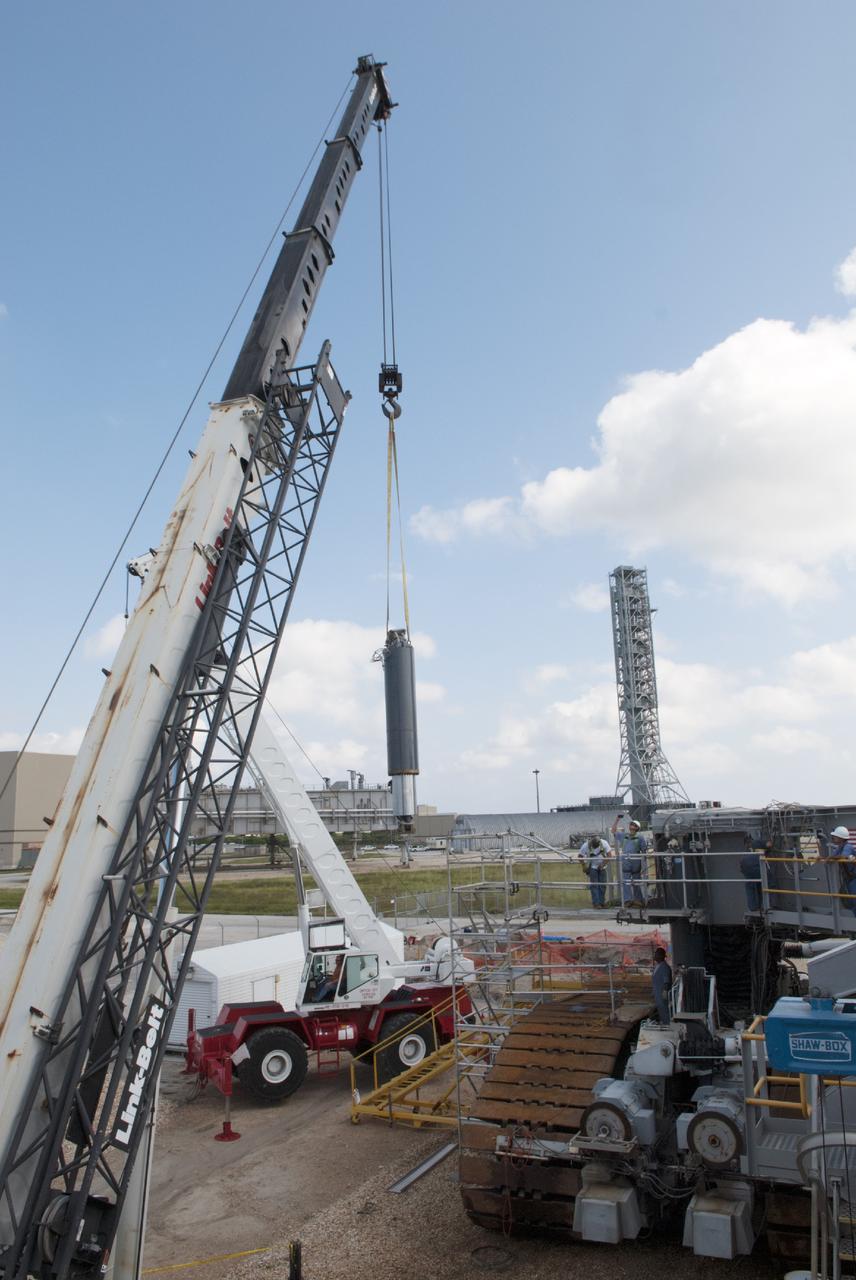 CAPE CANAVERAL, Fla. – One of the jacking, equalizing and leveling, or JEL, hydraulic cylinders is lifted away from crawler-transporter 1 at the crawler transporter maintenance facility at NASA’s Kennedy Space Center in Florida. Sixteen new JEL hydraulic cylinders will be installed on CT-1 to increase load carrying capacity and reliability. The Ground Systems Development and Operations Program at Kennedy continues to upgrade CT-1 as part of its general maintenance. CT-1 could be available to carry commercial launch vehicles to the launch pad. The crawler-transporters were used to carry the mobile launcher platform and space shuttle to Launch Complex 39 for space shuttle launches for 30 years. Photo credit: NASA/Tim Jacobs