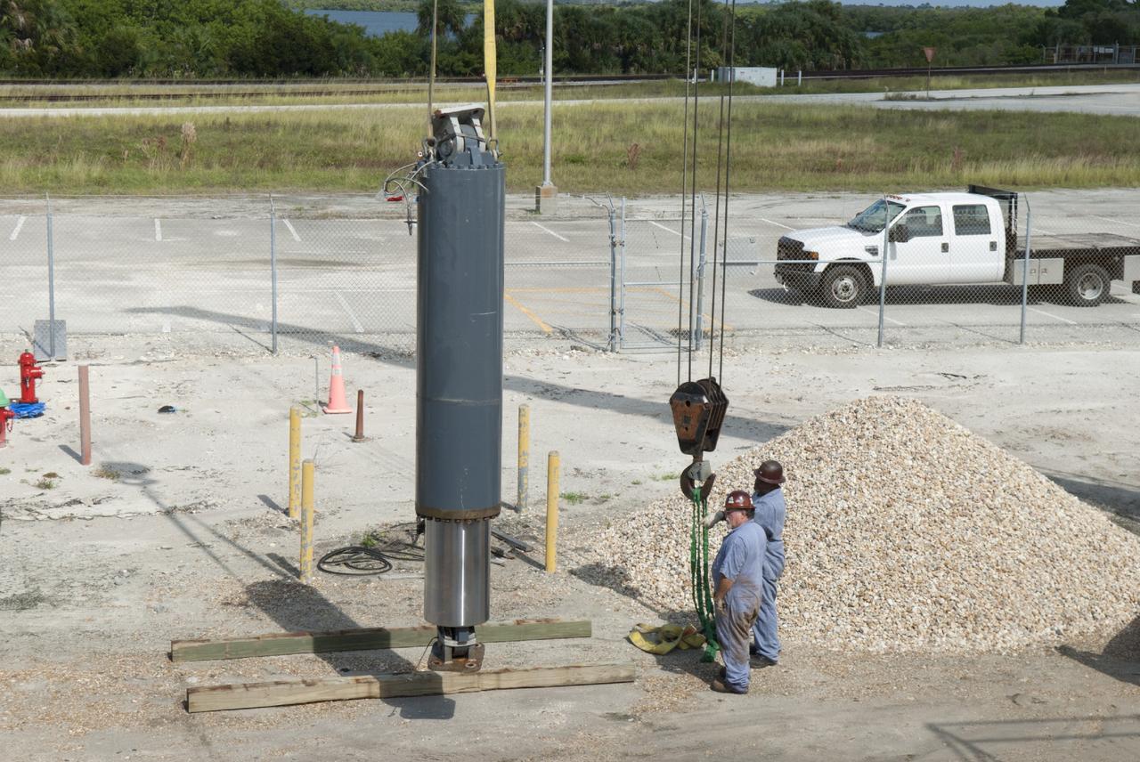 CAPE CANAVERAL, Fla. – Ground support equipment technicians monitor the progress as one of the jacking, equalizing and leveling, or JEL, hydraulic cylinders is lowered to the ground after it was removed from crawler-transporter 1. The work is being performed at the crawler transporter maintenance facility at NASA’s Kennedy Space Center in Florida. Sixteen new JEL hydraulic cylinders will be installed on CT-1 to increase load carrying capacity and reliability. The Ground Systems Development and Operations Program at Kennedy continues to upgrade CT-1 as part of its general maintenance. CT-1 could be available to carry commercial launch vehicles to the launch pad. The crawler-transporters were used to carry the mobile launcher platform and space shuttle to Launch Complex 39 for space shuttle launches for 30 years. Photo credit: NASA/Tim Jacobs