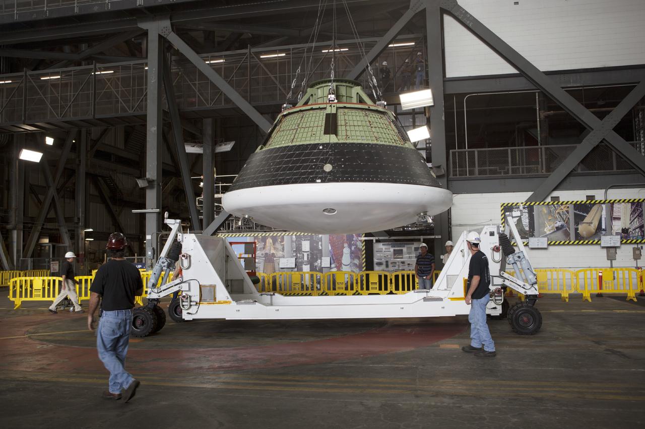 CAPE CANAVERAL, Fla. – At NASA’s Kennedy Space Center in Florida, technicians monitor the progress as the Orion ground test vehicle, or GTA, is lifted by crane in the transfer aisle of the Vehicle Assembly Building. The ground test vehicle is being used for path finding operations, including simulated manufacturing, assembly and stacking procedures. Orion is the exploration spacecraft designed to carry astronauts to destinations not yet explored by humans, including an asteroid and Mars. It will have emergency abort capability, sustain the crew during space travel and provide safe re-entry from deep space return velocities. The first unpiloted test flight of Orion is scheduled to launch in 2014 atop a Delta IV rocket and in 2017 on NASA’s Space Launch System rocket. For more information, visit www.nasa.gov/orion. Photo credit: Dimitri Gerondidakis