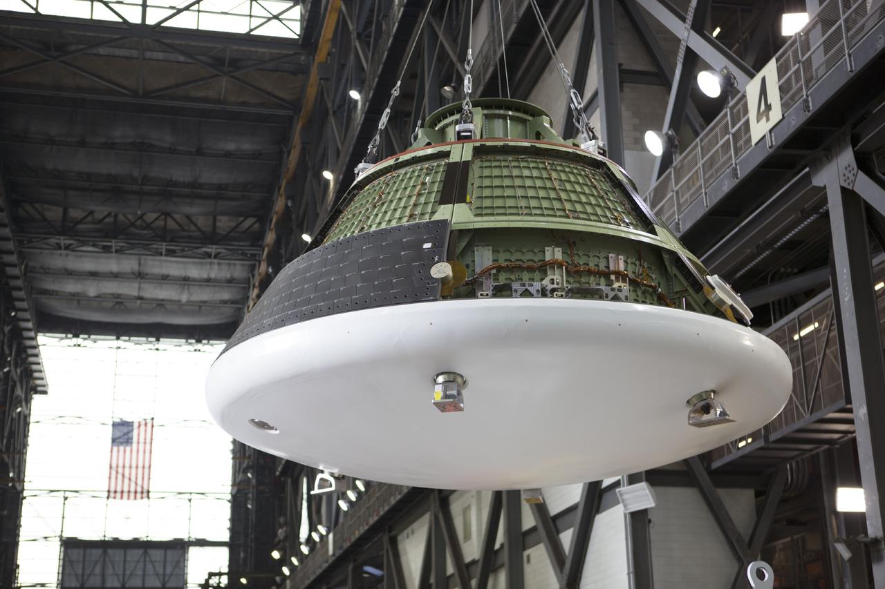 CAPE CANAVERAL, Fla. – At NASA’s Kennedy Space Center in Florida, the Orion test vehicle, or GTA, is lifted by crane in the transfer aisle of the Vehicle Assembly Building. The ground test vehicle is being used for path finding operations, including simulated manufacturing, assembly and stacking procedures. Orion is the exploration spacecraft designed to carry astronauts to destinations not yet explored by humans, including an asteroid and Mars. It will have emergency abort capability, sustain the crew during space travel and provide safe re-entry from deep space return velocities. The first unpiloted test flight of Orion is scheduled to launch in 2014 atop a Delta IV rocket and in 2017 on NASA’s Space Launch System rocket. For more information, visit www.nasa.gov/orion. Photo credit: Dimitri Gerondidakis