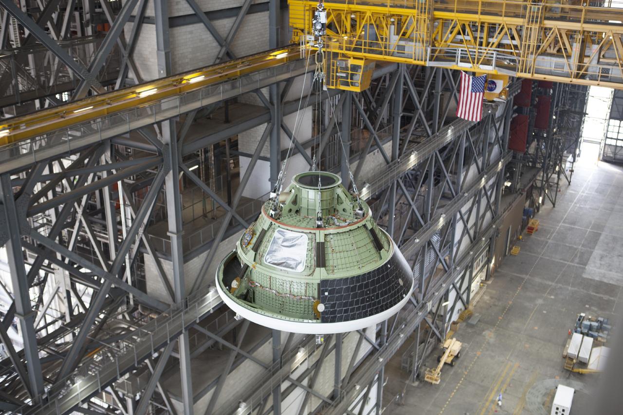 CAPE CANAVERAL, Fla. – At NASA’s Kennedy Space Center in Florida, a view from above shows the Orion ground test vehicle, or GTA, being lifted by crane in the transfer aisle of the Vehicle Assembly Building. The ground test vehicle is being used for path finding operations, including simulated manufacturing, assembly and stacking procedures. Orion is the exploration spacecraft designed to carry astronauts to destinations not yet explored by humans, including an asteroid and Mars. It will have emergency abort capability, sustain the crew during space travel and provide safe re-entry from deep space return velocities. The first unpiloted test flight of Orion is scheduled to launch in 2014 atop a Delta IV rocket and in 2017 on NASA’s Space Launch System rocket. For more information, visit www.nasa.gov/orion. Photo credit: Dimitri Gerondidakis