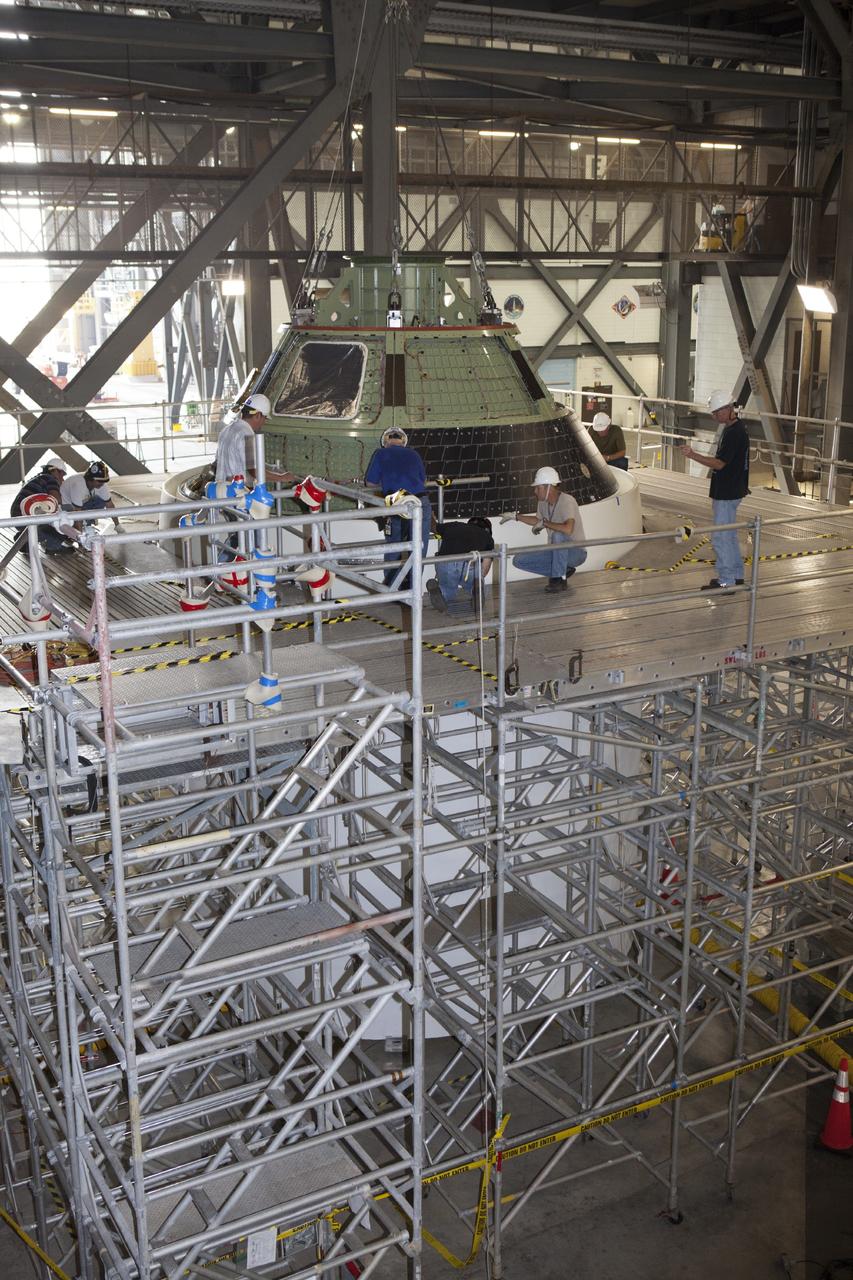 CAPE CANAVERAL, Fla. – At NASA’s Kennedy Space Center in Florida, technicians attach the Orion ground test vehicle, or GTA, to a mockup of the service module in high bay 4 of the Vehicle Assembly Building. The ground test vehicle is being used for path finding operations, including simulated manufacturing, assembly and stacking procedures. Orion is the exploration spacecraft designed to carry astronauts to destinations not yet explored by humans, including an asteroid and Mars. It will have emergency abort capability, sustain the crew during space travel and provide safe re-entry from deep space return velocities. The first unpiloted test flight of Orion is scheduled to launch in 2014 atop a Delta IV rocket and in 2017 on NASA’s Space Launch System rocket. For more information, visit www.nasa.gov/orion. Photo credit: Dimitri Gerondidakis