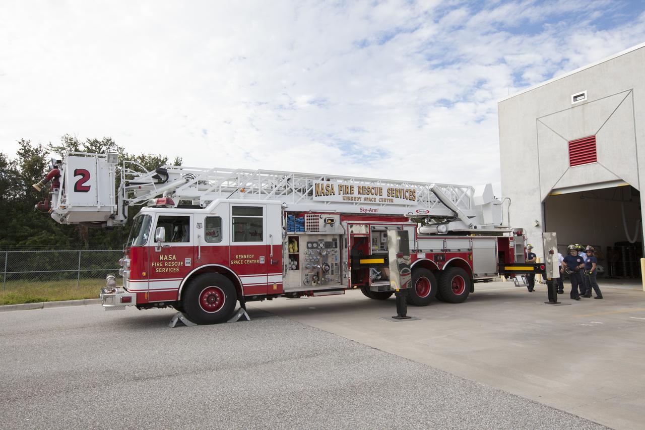 CAPE CANAVERAL, Fla. – At Fire Station No. 2 near the Shuttle Landing Facility at NASA’s Kennedy Space Center in Florida, the aerial fire truck has been moved out of the bay and Fire Rescue Services personnel have deployed the stabilizers on either side of the truck in order to prepare for training to be certified in the operation and use of the vehicle.    The center’s Fire Rescue Services recently achieved Pro Board Certification in aerial fire truck operations. Pro Board Certification is a globally recognized certification that puts on multiple courses that all fire departments throughout the world recognize and use to train their personnel. The unique aerial truck contains a 100-foot extendable ladder with a bucket at the end of it that can be used for rescues from taller buildings or aircraft rescue firefighting. Photo credit: NASA/Kim Shiflett