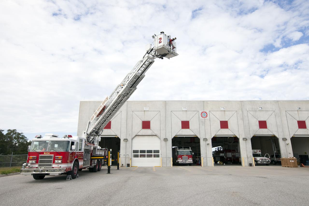 CAPE CANAVERAL, Fla. – At Fire Station No. 2 near the Shuttle Landing Facility at NASA’s Kennedy Space Center in Florida, Fire Rescue Services personnel have deployed the ladder on the aerial fire truck during training in order to be certified in the operation and use of the vehicle.    The center’s Fire Rescue Services recently achieved Pro Board Certification in aerial fire truck operations. Pro Board Certification is a globally recognized certification that puts on multiple courses that all fire departments throughout the world recognize and use to train their personnel. The unique aerial truck contains a 100-foot extendable ladder with a bucket at the end of it that can be used for rescues from taller buildings or aircraft rescue firefighting. Photo credit: NASA/Kim Shiflett