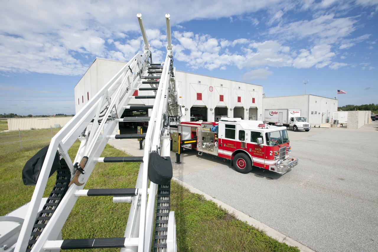 CAPE CANAVERAL, Fla. – At Fire Station No. 2 near the Shuttle Landing Facility at NASA’s Kennedy Space Center in Florida, Fire Rescue Services personnel have deployed and extended the ladder on the aerial fire truck during training in order to be certified in the operation and use of the vehicle. The stabilizers have been deployed on either side of the fire truck.     The center’s Fire Rescue Services recently achieved Pro Board Certification in aerial fire truck operations. Pro Board Certification is a globally recognized certification that puts on multiple courses that all fire departments throughout the world recognize and use to train their personnel. The unique aerial truck contains a 100-foot extendable ladder with a bucket at the end of it that can be used for rescues from taller buildings or aircraft rescue firefighting. Photo credit: NASA/Kim Shiflett