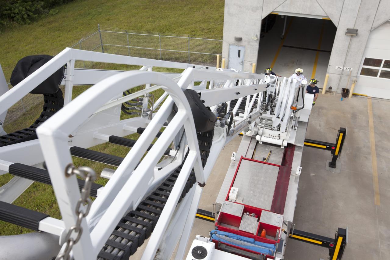 CAPE CANAVERAL, Fla. – At Fire Station No. 2 near the Shuttle Landing Facility at NASA’s Kennedy Space Center in Florida, Fire Rescue Services personnel have deployed and extended the ladder on the aerial fire truck during training in order to be certified in the operation and use of the vehicle. The stabilizers have been deployed on either side of the fire truck.    The center’s Fire Rescue Services recently achieved Pro Board Certification in aerial fire truck operations. Pro Board Certification is a globally recognized certification that puts on multiple courses that all fire departments throughout the world recognize and use to train their personnel. The unique aerial truck contains a 100-foot extendable ladder with a bucket at the end of it that can be used for rescues from taller buildings or aircraft rescue firefighting. Photo credit: NASA/Kim Shiflett