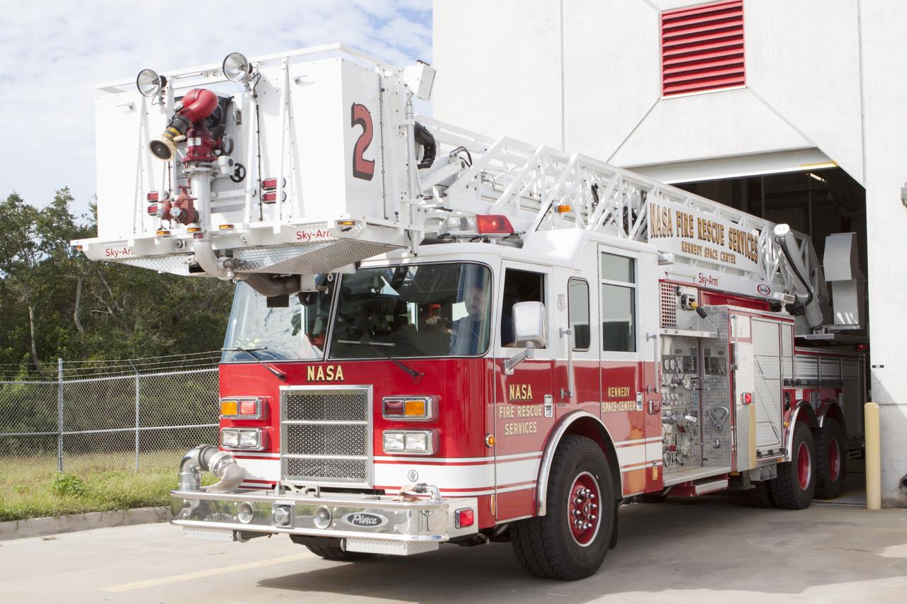 CAPE CANAVERAL, Fla. – At Fire Station No. 2 near the Shuttle Landing Facility at NASA’s Kennedy Space Center in Florida, the aerial fire truck is being driven out of the bay so that Fire Rescue Services personnel can be trained and certified in the operation and use of the vehicle.    The center’s Fire Rescue Services recently achieved Pro Board Certification in aerial fire truck operations. Pro Board Certification is a globally recognized certification that puts on multiple courses that all fire departments throughout the world recognize and use to train their personnel. The unique aerial truck contains a 100-foot extendable ladder with a bucket at the end of it that can be used for rescues from taller buildings or aircraft rescue firefighting. Photo credit: NASA/Kim Shiflett