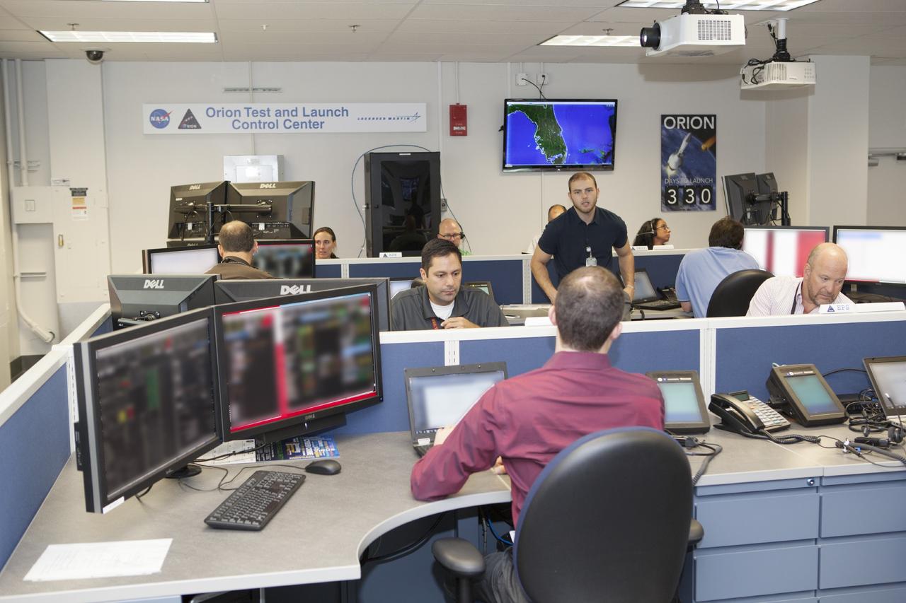 CAPE CANAVERAL, Fla. – Inside the Orion Test and Launch Control Center at NASA’s Kennedy Space Center in Florida, engineers prepare for the first Exploration Flight Test 1, or EFT-1, power up test. NASA’s first-ever deep space craft, Orion, was powered on for the first time, marking a major milestone in the final year of preparations for flight. Orion’s avionics system was installed on the crew module and powered up for a series of systems tests.    Orion is the exploration spacecraft designed to carry astronauts to destinations not yet explored by humans, including an asteroid and Mars. It will have emergency abort capability, sustain the crew during space travel and provide safe re-entry from deep space return velocities. The first unpiloted test flight of Orion, EFT-1, is scheduled to launch in 2014 atop a Delta IV rocket and in 2017 on NASA’s Space Launch System rocket. For more information, visit www.nasa.gov/orion. Photo credit: Dimitri Gerondidakis