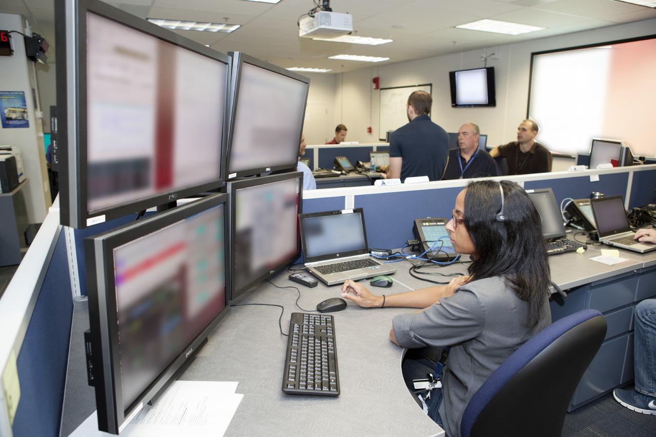 CAPE CANAVERAL, Fla. – Inside the Orion Test and Launch Control Center at NASA’s Kennedy Space Center in Florida, engineers prepare for the first Exploration Flight Test 1, or EFT-1, power up test. NASA’s first-ever deep space craft, Orion, was powered on for the first time, marking a major milestone in the final year of preparations for flight. Orion’s avionics system was installed on the crew module and powered up for a series of systems tests.    Orion is the exploration spacecraft designed to carry astronauts to destinations not yet explored by humans, including an asteroid and Mars. It will have emergency abort capability, sustain the crew during space travel and provide safe re-entry from deep space return velocities. The first unpiloted test flight of Orion, EFT-1, is scheduled to launch in 2014 atop a Delta IV rocket and in 2017 on NASA’s Space Launch System rocket. For more information, visit www.nasa.gov/orion. Photo credit: Dimitri Gerondidakis