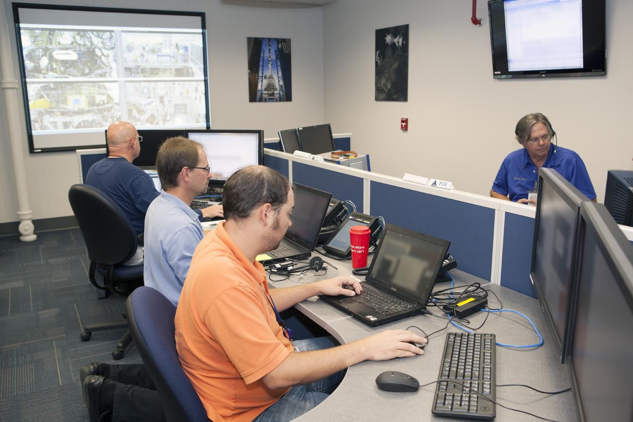 CAPE CANAVERAL, Fla. – Inside the Orion Test and Launch Control Center at NASA’s Kennedy Space Center in Florida, engineers prepare for the first Exploration Flight Test 1, or EFT-1, power up test. NASA’s first-ever deep space craft, Orion, was powered on for the first time, marking a major milestone in the final year of preparations for flight. Orion’s avionics system was installed on the crew module and powered up for a series of systems tests.    Orion is the exploration spacecraft designed to carry astronauts to destinations not yet explored by humans, including an asteroid and Mars. It will have emergency abort capability, sustain the crew during space travel and provide safe re-entry from deep space return velocities. The first unpiloted test flight of Orion, EFT-1, is scheduled to launch in 2014 atop a Delta IV rocket and in 2017 on NASA’s Space Launch System rocket. For more information, visit www.nasa.gov/orion. Photo credit: Dimitri Gerondidakis
