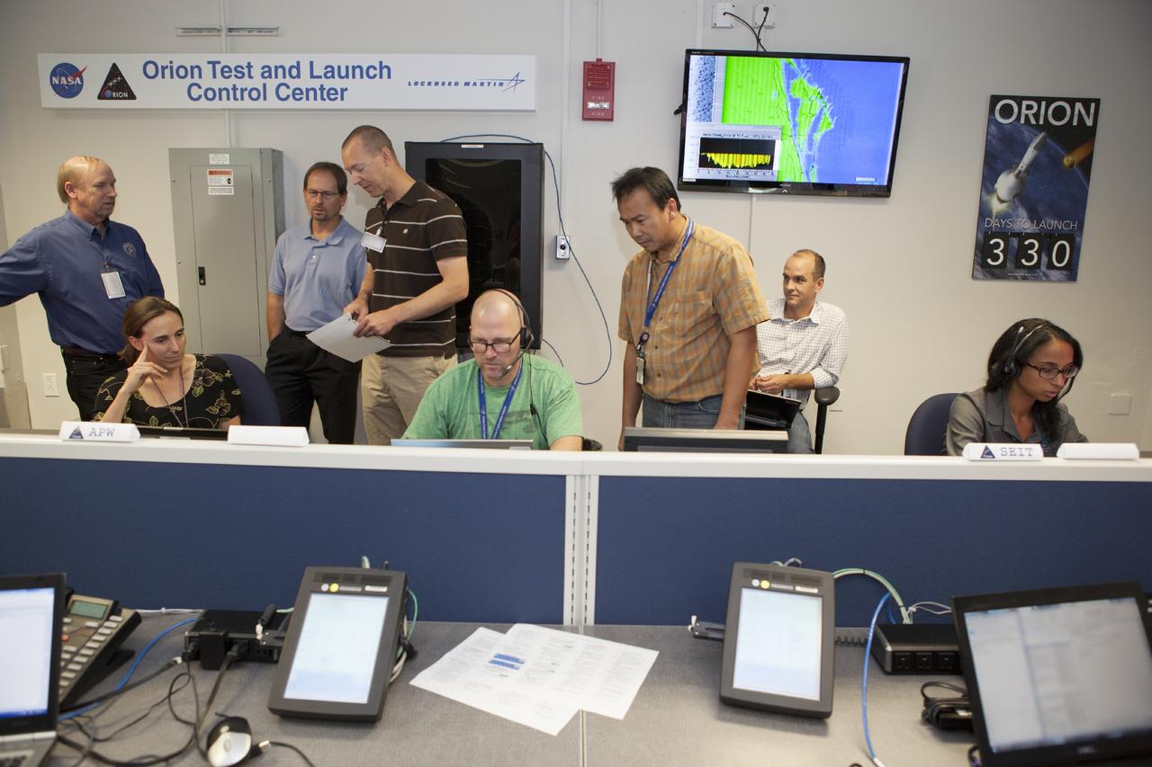 CAPE CANAVERAL, Fla. – Inside the Orion Test and Launch Control Center at NASA’s Kennedy Space Center in Florida, engineers monitor data during the first Exploration Flight Test 1, or EFT-1, power up test. NASA’s first-ever deep space craft, Orion, was powered on for the first time, marking a major milestone in the final year of preparations for flight. Orion’s avionics system was installed on the crew module and powered up for a series of systems tests.    Orion is the exploration spacecraft designed to carry astronauts to destinations not yet explored by humans, including an asteroid and Mars. It will have emergency abort capability, sustain the crew during space travel and provide safe re-entry from deep space return velocities. The first unpiloted test flight of Orion, EFT-1, is scheduled to launch in 2014 atop a Delta IV rocket and in 2017 on NASA’s Space Launch System rocket. For more information, visit www.nasa.gov/orion. Photo credit: Dimitri Gerondidakis