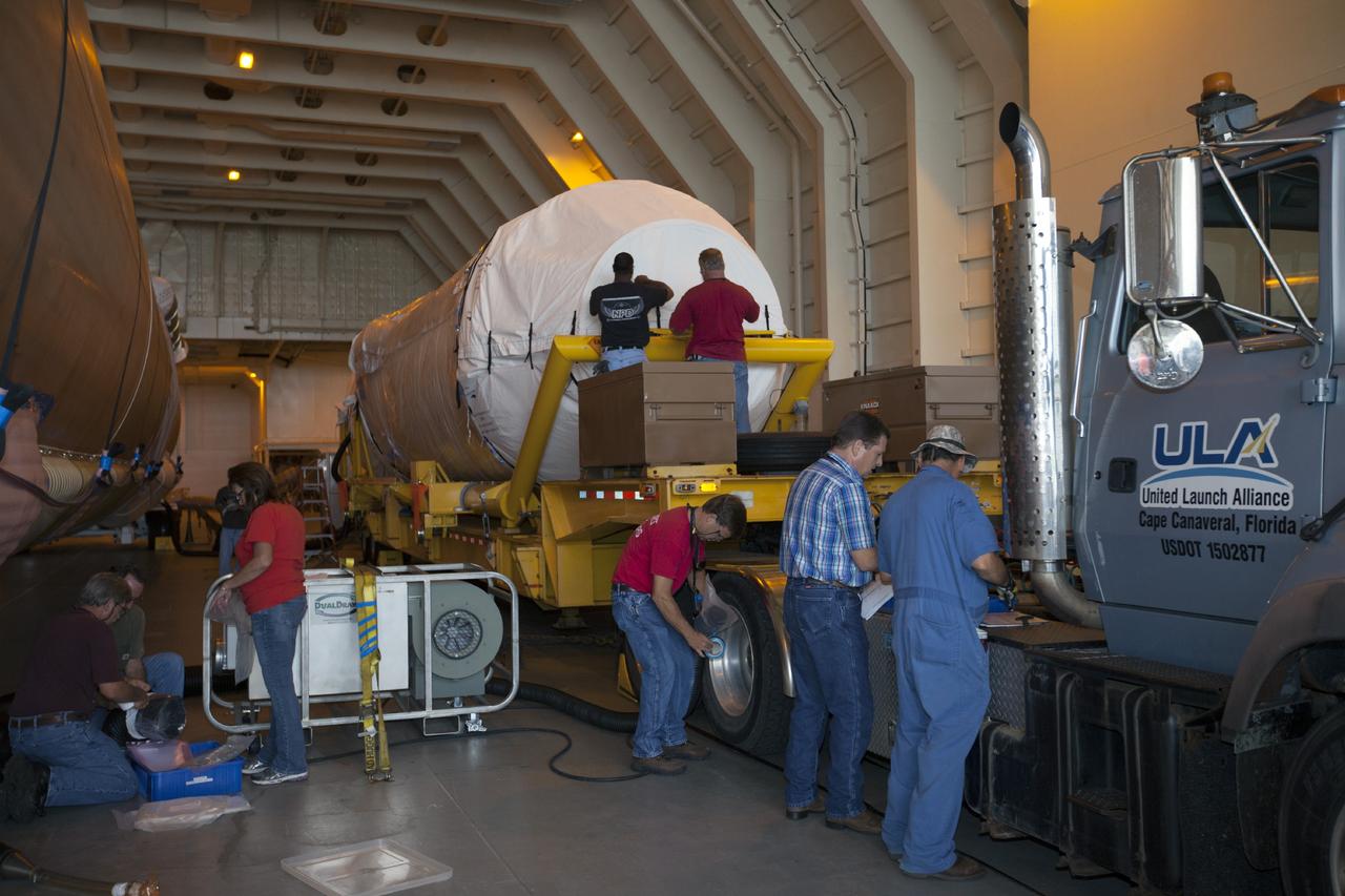 PORT CANAVERAL, Fla. – Following arrival of the United Launch Alliance barge, Delta Mariner, at Port Canaveral, Fla. engineers and technicians prepare to offload the Atlas V launch vehicle that will boost the Tracking and Data Relay Satellite, or TDRS-L, spacecraft into orbit around the Earth. The rocket's first-stage booster and Centaur upper stage will be transported to the hangar at the Atlas Spaceflight Operations Center on Cape Canaveral Air Force Station for checkout in preparation for launch.      TDRS-L is the second of three next-generation satellites designed to ensure vital operational continuity for the NASA Space Network. It is scheduled to launch from Cape Canaveral's Space Launch Complex 41 atop an Atlas V rocket in January 2014. The current Tracking and Data Relay Satellite system consists of eight in-orbit satellites distributed to provide near continuous information relay service to missions such as the Hubble Space Telescope and International Space Station. For more information, visit: http://www.nasa.gov/content/tracking-and-data-relay-satellite-tdrs/ Photo credit: NASA/ Kim Shiflett