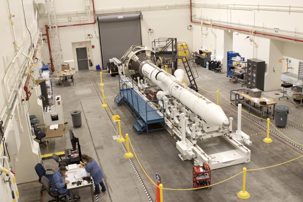 CAPE CANAVERAL, Fla. – Inside the Launch Abort System Facility at NASA’s Kennedy Space Center in Florida, technicians prepare to work on the launch abort system, or LAS, for the Orion Exploration Flight Test-1 mission. Horizontally stacked together are the components of the LAS, the launch abort motor, the attitude control motor, the jettison motor and the fairing.    Orion is the exploration spacecraft designed to carry crews to space beyond low Earth orbit. It will provide emergency abort capability, sustain the crew during the space travel and provide safe re-entry from deep space return velocities. The LAS is designed to safely pull the Orion crew module away from the launch vehicle in the event of an emergency on the launch pad or during the initial ascent of NASA’s Space Launch System, or SLS, rocket. Orion’s first unpiloted test flight is scheduled to launch in 2014 atop a Delta IV rocket. A second uncrewed flight test is scheduled for 2017 on the SLS rocket. For more information, visit http://www.nasa.gov/orion. Photo credit: NASA/Jim Grossmann
