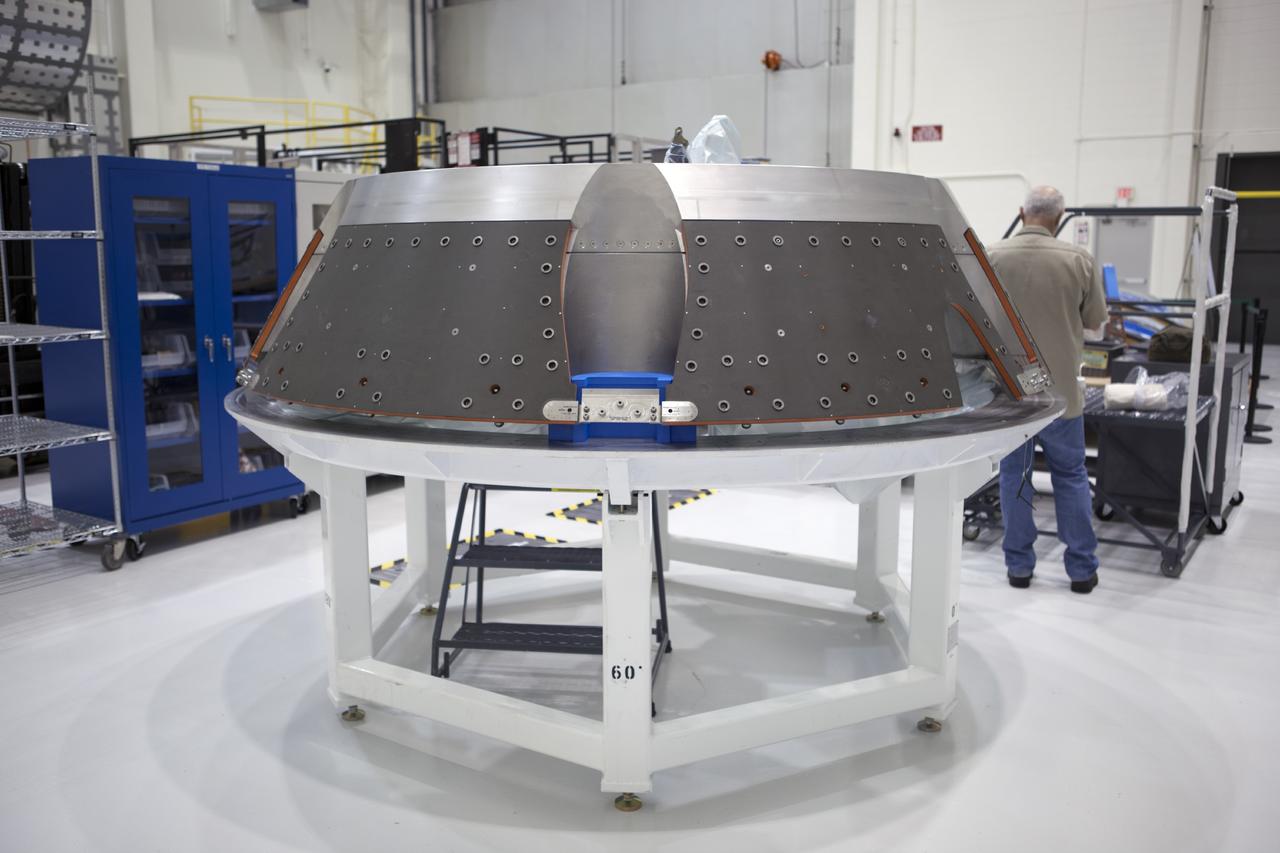 CAPE CANAVERAL, Fla. – Inside the Operations and Checkout Building high bay at NASA’s Kennedy Space Center in Florida, processing work continues as a technician prepares the forward bay cover for the Orion crew module. Orion is the exploration spacecraft designed to carry astronauts to destinations not yet explored by humans, including an asteroid and Mars. It will have emergency abort capability, sustain the crew during space travel and provide safe re-entry from deep space return velocities. The first unpiloted test flight of the Orion is scheduled to launch in 2014 atop a Delta IV rocket and in 2017 on NASA’s Space Launch System rocket. For more information, visit http://www.nasa.gov/orion. Photo credit: NASA/Dimitri Gerondidakis