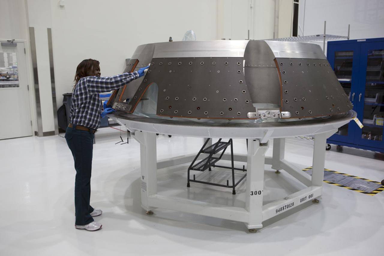 CAPE CANAVERAL, Fla. – Inside the Operations and Checkout Building high bay at NASA’s Kennedy Space Center in Florida, a technician prepares the forward bay cover for the Orion crew module. Orion is the exploration spacecraft designed to carry astronauts to destinations not yet explored by humans, including an asteroid and Mars. It will have emergency abort capability, sustain the crew during space travel and provide safe re-entry from deep space return velocities. The first unpiloted test flight of the Orion is scheduled to launch in 2014 atop a Delta IV rocket and in 2017 on NASA’s Space Launch System rocket. For more information, visit http://www.nasa.gov/orion. Photo credit: NASA/Dimitri Gerondidakis