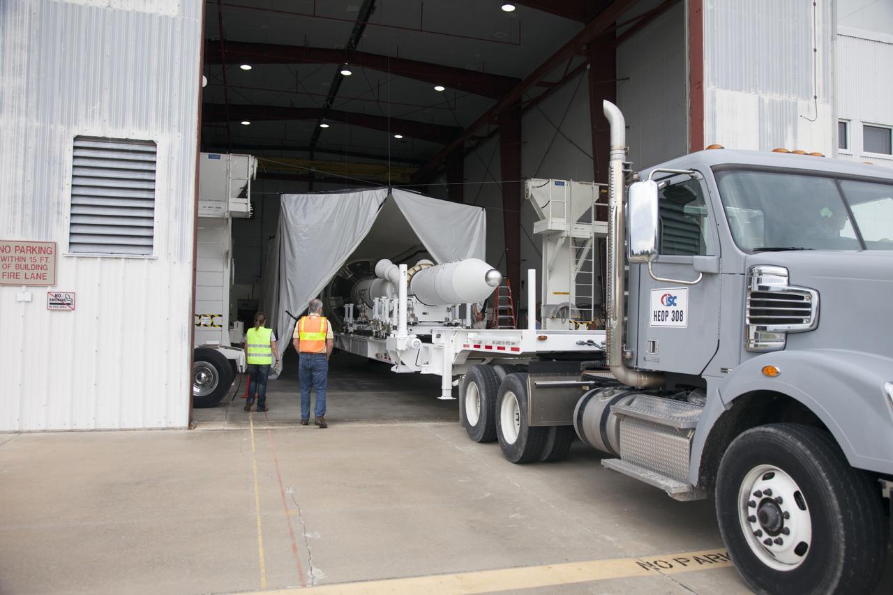 CAPE CANAVERAL, Fla. – At the Launch Abort System Facility at NASA’s Kennedy Space Center in Florida, the launch abort system, or LAS, for the Orion Exploration Flight Test-1, is backed by flatbed truck into a low bay at the facility. The low bay has been prepared for additional LAS processing. Orion is the exploration spacecraft designed to carry crews to space beyond low Earth orbit. It will provide emergency abort capability, sustain the crew during the space travel and provide safe re-entry from deep space return velocities. The LAS is designed to safely pull the Orion crew module away from the launch vehicle in the event of an emergency on the launch pad or during the initial ascent of NASA’s Space Launch System, or SLS, rocket. Orion’s first unpiloted test flight is scheduled to launch in 2014 atop a Delta IV rocket. A second uncrewed flight test is scheduled for 2017 on the SLS rocket. For more information, visit http://www.nasa.gov/orion. Photo credit: NASA/Daniel Casper