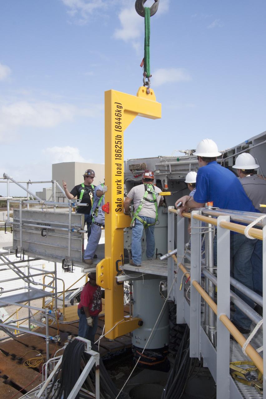CAPE CANAVERAL, Fla. – Ground support equipment technicians assist as a crane is used to move a new jacking, equalizing and leveling, or JEL, hydraulic cylinder closer for installation on crawler-transporter 1 at the crawler transporter maintenance facility at NASA’s Kennedy Space Center in Florida. New JEL hydraulic cylinders will be installed on CT-1 to test them for increased load carrying capacity and reliability. The Ground Systems Development and Operations Program at Kennedy continues to upgrade CT-1 as part of its general maintenance. CT-1 could be available to carry a variety of launch vehicles to the launch pad. Two crawler-transporters were used to carry the mobile launcher platform and space shuttle to Launch Complex 39 for space shuttle launches for 30 years. Photo credit: NASA/Jim Grossmann