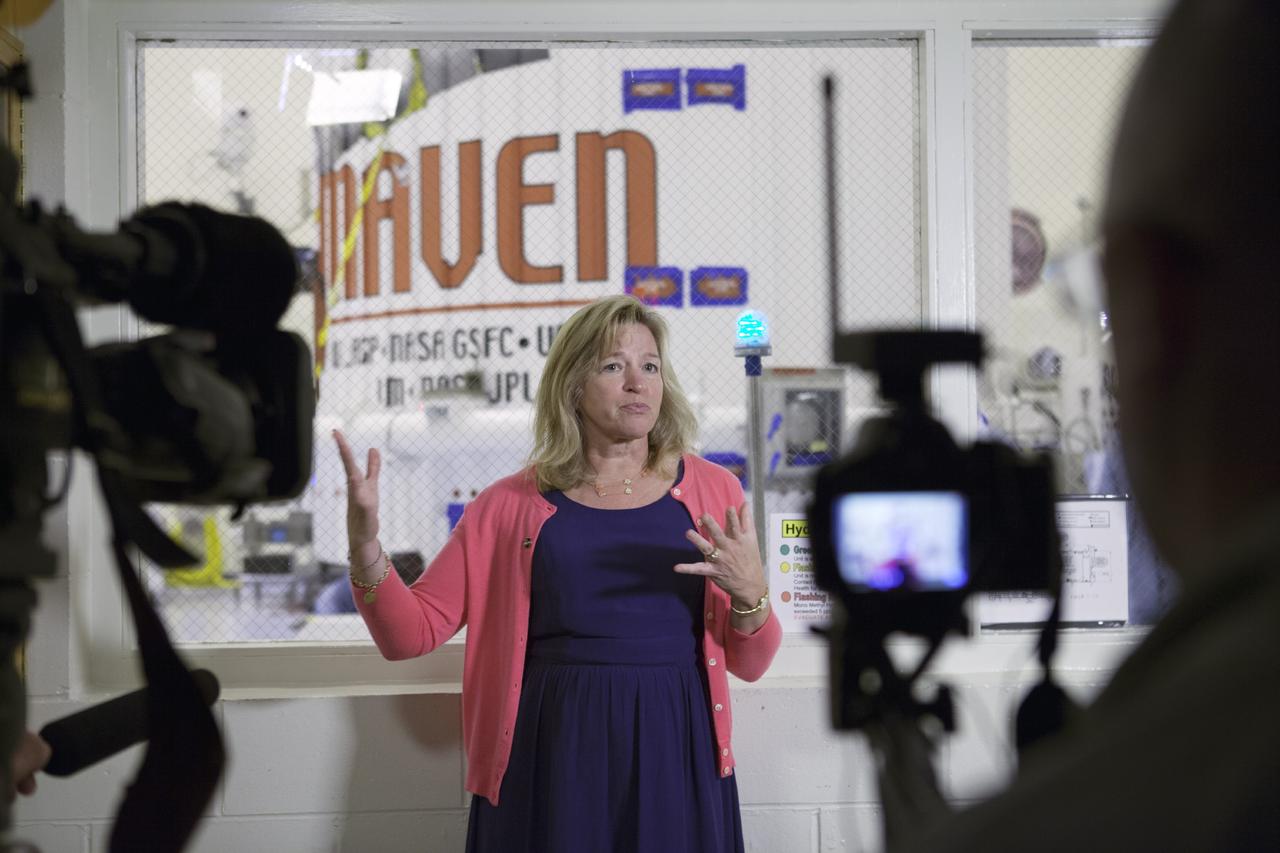 CAPE CANAVERAL, Fla. – Inside the Payload Hazardous Servicing Facility at NASA's Kennedy Space Center in Florida, Dr. Ellen Stofan, NASA's chief scientist, speaks to members of the news media. The Mars Atmosphere and Volatile Evolution, or MAVEN, spacecraft is in the background following encapsulation in its payload fairing.      MAVEN is being prepared for its scheduled launch on Nov 18, 2013 from Cape Canaveral Air Force Station, Fla. atop a United Launch Alliance Atlas V rocket. Positioned in an orbit above the Red Planet, MAVEN will study the upper atmosphere of Mars in unprecedented detail. For more information, visit: http://www.nasa.gov/mission_pages/maven/main/index.html Photo credit: NASA/Kim Shiflett