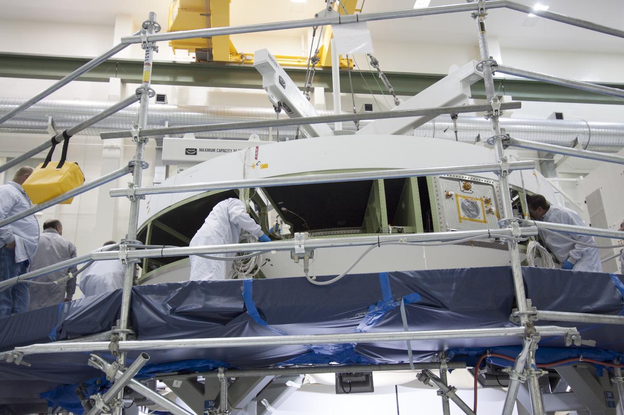 CAPE CANAVERAL, Fla. – Inside the Operations and Checkout Building high bay at NASA’s Kennedy Space Center in Florida, technicians check to make sure the service module for the Orion spacecraft is secured to the lifting crane. The service module will be transferred from the tooling stand onto a lift station where it will be mated to the spacecraft adapter cone. Orion is the exploration spacecraft designed to carry astronauts to destinations not yet explored by humans, including an asteroid and Mars. It will have emergency abort capability, sustain the crew during space travel and provide safe re-entry from deep space return velocities. The first unpiloted test flight of the Orion is scheduled to launch in 2014 atop a Delta IV rocket and in 2017 on NASA’s Space Launch System rocket. For more information, visit http://www.nasa.gov/orion. Photo credit: NASA/Jim Grossmann