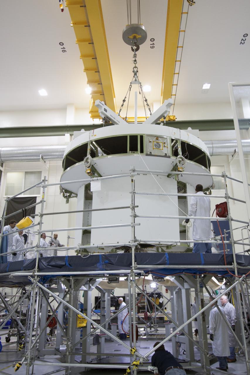 CAPE CANAVERAL, Fla. – Inside the Operations and Checkout Building high bay at NASA’s Kennedy Space Center in Florida, a crane is used to lift the service module for the Orion spacecraft from the tooling stand. The service module will be transferred to a lift station where it will be mated to the spacecraft adapter cone. Orion is the exploration spacecraft designed to carry astronauts to destinations not yet explored by humans, including an asteroid and Mars. It will have emergency abort capability, sustain the crew during space travel and provide safe re-entry from deep space return velocities. The first unpiloted test flight of the Orion is scheduled to launch in 2014 atop a Delta IV rocket and in 2017 on NASA’s Space Launch System rocket. For more information, visit http://www.nasa.gov/orion. Photo credit: NASA/Jim Grossmann