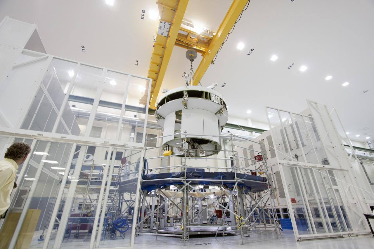 CAPE CANAVERAL, Fla. – Inside the Operations and Checkout Building high bay at NASA’s Kennedy Space Center in Florida, a crane is used to lift the service module for the Orion spacecraft from the tooling stand. The service module will be transferred to a lift station where it will be mated to the spacecraft adapter cone. Orion is the exploration spacecraft designed to carry astronauts to destinations not yet explored by humans, including an asteroid and Mars. It will have emergency abort capability, sustain the crew during space travel and provide safe re-entry from deep space return velocities. The first unpiloted test flight of the Orion is scheduled to launch in 2014 atop a Delta IV rocket and in 2017 on NASA’s Space Launch System rocket. For more information, visit http://www.nasa.gov/orion. Photo credit: NASA/Jim Grossmann