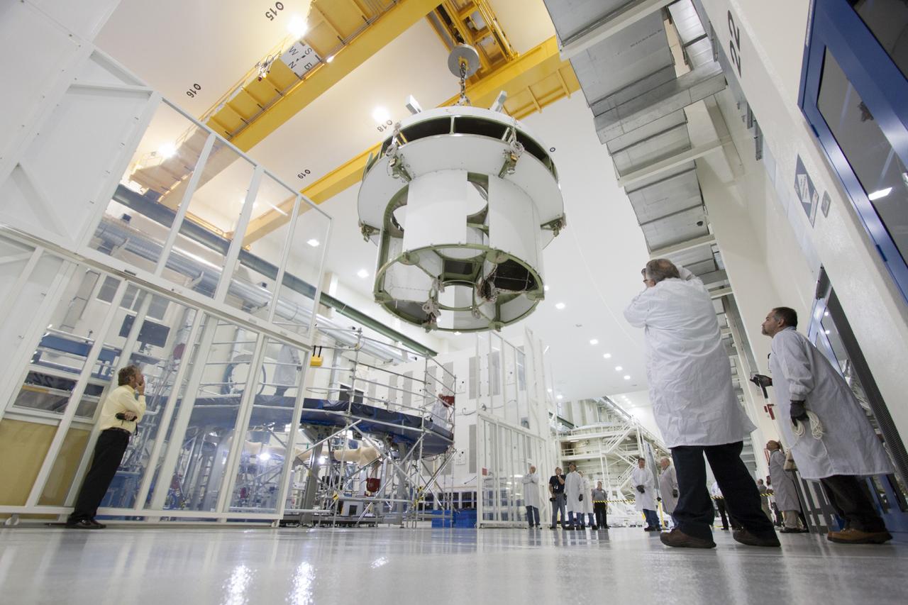 CAPE CANAVERAL, Fla. – Inside the Operations and Checkout Building high bay at NASA’s Kennedy Space Center in Florida, a crane is used to move the service module for the Orion spacecraft from the tooling stand. The service module will be transferred to a lift station where it will be mated to the spacecraft adapter cone. Orion is the exploration spacecraft designed to carry astronauts to destinations not yet explored by humans, including an asteroid and Mars. It will have emergency abort capability, sustain the crew during space travel and provide safe re-entry from deep space return velocities. The first unpiloted test flight of the Orion is scheduled to launch in 2014 atop a Delta IV rocket and in 2017 on NASA’s Space Launch System rocket. For more information, visit http://www.nasa.gov/orion. Photo credit: NASA/Jim Grossmann