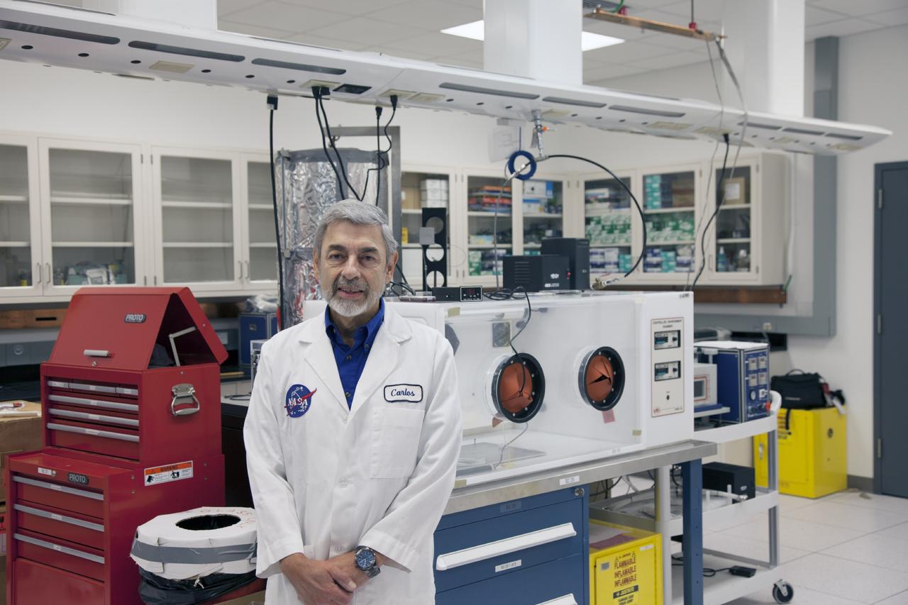 CAPE CANAVERAL, Fla. -- Dr. Carlos Calle, senior research scientist on the Electrodynamic Dust Shield for Dust Mitigation project, manages the Electrostatics and Surface Physics Laboratory in the SwampWorks at NASA's Kennedy Space Center in Florida.      Electrodynamic dust shield, or EDS, technology is based on concepts originally developed by NASA as early as 1967 and later by the University of Tokyo. In 2003, NASA, in collaboration with the University of Arkansas at Little Rock, started development of the EDS for dust particle removal from solar panels to be used on future missions to the moon, an asteroid or Mars. A flight experiment to expose the dust shields to the space environment currently is under development. For more information, visit: http://www.nasa.gov/content/scientists-developing-ways-to-mitigate-dust-problem-for-explorers/ Photo credit: NASA/Dan Casper
