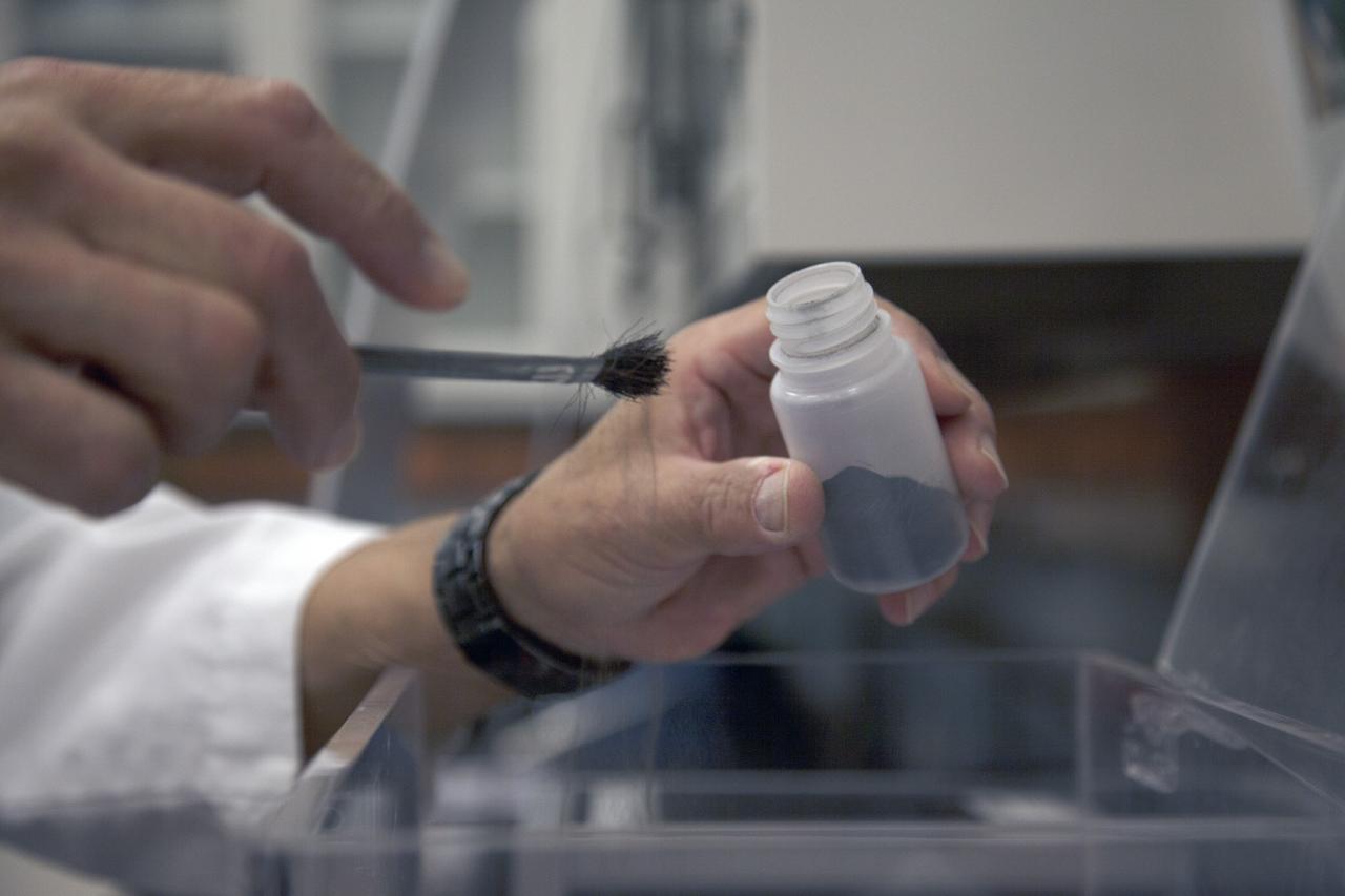 CAPE CANAVERAL, Fla. -- Dr. Carlos Calle, senior research scientist on the Electrodynamic Dust Shield for Dust Mitigation project, works with dust fabricated for use in his experiments in the Electrostatics and Surface Physics Laboratory in the SwampWorks at NASA's Kennedy Space Center in Florida. The fabricated material is designed to mimic the dust on the lunar surface. The technology works by creating an electric field that propagates out like the ripples on a pond. This could prevent dust accumulation on spacesuits, thermal radiators, solar panels, optical instruments and view ports for future lunar and Mars exploration activities.      Electrodynamic dust shield, or EDS, technology is based on concepts originally developed by NASA as early as 1967 and later by the University of Tokyo. In 2003, NASA, in collaboration with the University of Arkansas at Little Rock, started development of the EDS for dust particle removal from solar panels to be used on future missions to the moon, an asteroid or Mars. A flight experiment to expose the dust shields to the space environment currently is under development. For more information, visit: http://www.nasa.gov/content/scientists-developing-ways-to-mitigate-dust-problem-for-explorers/ Photo credit: NASA/Dan Casper