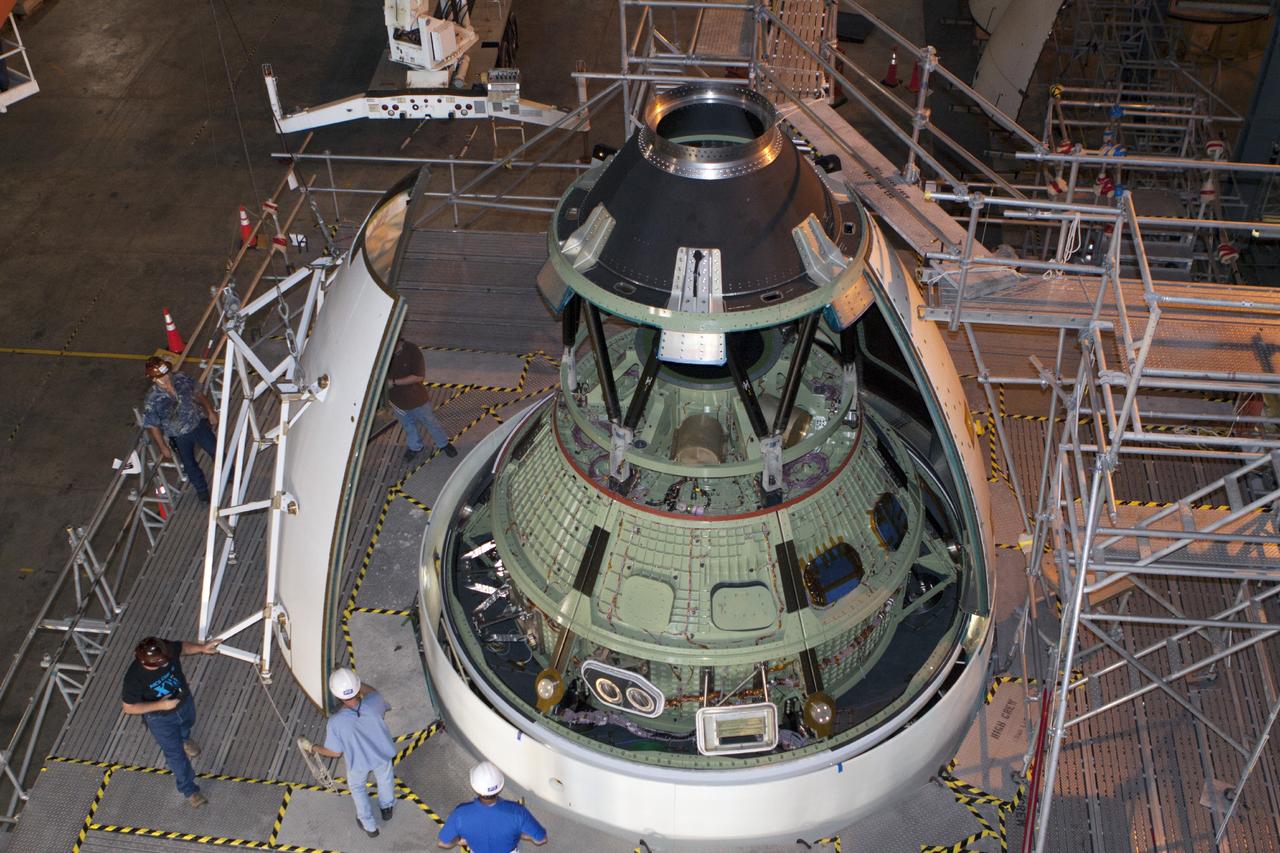 CAPE CANAVERAL, Fla. – At NASA’s Kennedy Space Center in Florida, technicians use a special handling device to bring an ogive panel closer for installation on the Orion ground test vehicle in Vehicle Assembly Building high bay 4. The ogive panels enclose the Orion spacecraft and attach to the Launch Abort System. The test vehicle is being used by the Ground Systems Development and Operations Program for path finding operations, including simulated manufacturing, assembly and stacking procedures. Orion is the exploration spacecraft designed to carry astronauts to destinations not yet explored by humans, including an asteroid and Mars. It will have emergency abort capability, sustain the crew during space travel and provide safe re-entry from deep space return velocities. The first unpiloted test flight of Orion is scheduled to launch in 2014 atop a Delta IV rocket and in 2017 on NASA’s Space Launch System rocket. For more information, visit www.nasa.gov/orion. Photo credit: Kim Shiflett