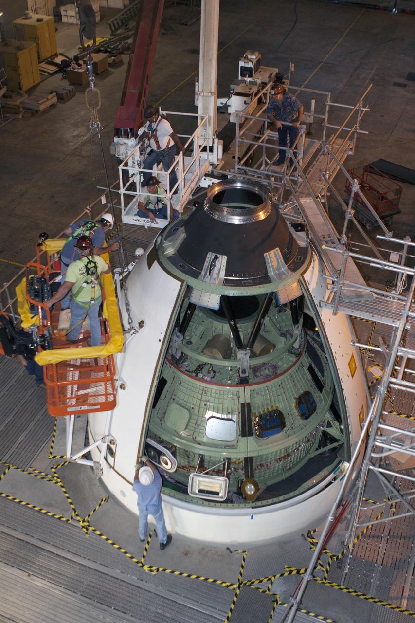 CAPE CANAVERAL, Fla. – At NASA’s Kennedy Space Center in Florida, technicians attach an ogive panel on the Orion ground test vehicle in Vehicle Assembly Building high bay 4. The ogive panels enclose the Orion spacecraft and attach to the Launch Abort System. The test vehicle is being used by the Ground Systems Development and Operations Program for path finding operations, including simulated manufacturing, assembly and stacking procedures. Orion is the exploration spacecraft designed to carry astronauts to destinations not yet explored by humans, including an asteroid and Mars. It will have emergency abort capability, sustain the crew during space travel and provide safe re-entry from deep space return velocities. The first unpiloted test flight of Orion is scheduled to launch in 2014 atop a Delta IV rocket and in 2017 on NASA’s Space Launch System rocket. For more information, visit www.nasa.gov/orion. Photo credit: Kim Shiflett