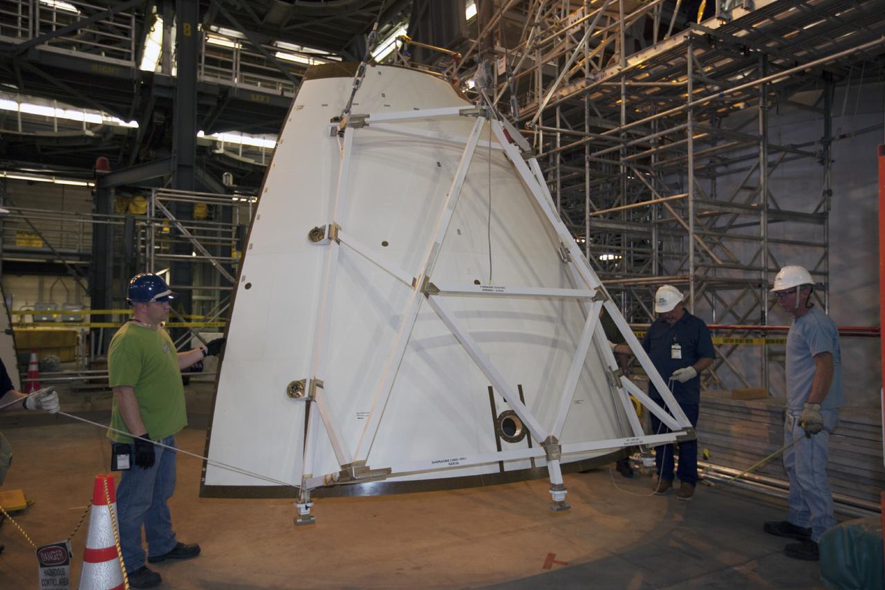 CAPE CANAVERAL, Fla. – At NASA’s Kennedy Space Center in Florida, technicians prepare an ogive panel for installation on the Orion ground test vehicle in Vehicle Assembly Building high bay 4. The ogive panels enclose the Orion spacecraft and attach to the Launch Abort System. The test vehicle is being used by the Ground Systems Development and Operations Program for path finding operations, including simulated manufacturing, assembly and stacking procedures. Orion is the exploration spacecraft designed to carry astronauts to destinations not yet explored by humans, including an asteroid and Mars. It will have emergency abort capability, sustain the crew during space travel and provide safe re-entry from deep space return velocities. The first unpiloted test flight of Orion is scheduled to launch in 2014 atop a Delta IV rocket and in 2017 on NASA’s Space Launch System rocket. For more information, visit www.nasa.gov/orion. Photo credit: Kim Shiflett