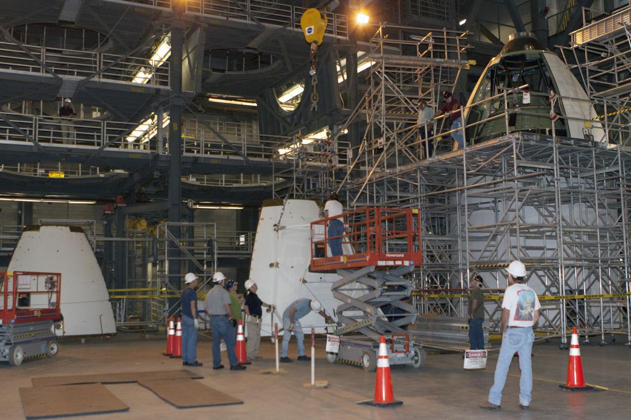 CAPE CANAVERAL, Fla. – At NASA’s Kennedy Space Center in Florida, technicians prepare an ogive panel for lifting by crane so that it can be installed on the Orion ground test vehicle in Vehicle Assembly Building high bay 4. The ogive panels enclose the Orion spacecraft and attach to the Launch Abort System. The test vehicle is being used Ground Systems Development and Operations Program for path finding operations, including simulated manufacturing, assembly and stacking procedures. Orion is the exploration spacecraft designed to carry astronauts to destinations not yet explored by humans, including an asteroid and Mars. It will have emergency abort capability, sustain the crew during space travel and provide safe re-entry from deep space return velocities. The first unpiloted test flight of Orion is scheduled to launch in 2014 atop a Delta IV rocket and in 2017 on NASA’s Space Launch System rocket. For more information, visit www.nasa.gov/orion. Photo credit: Kim Shiflett