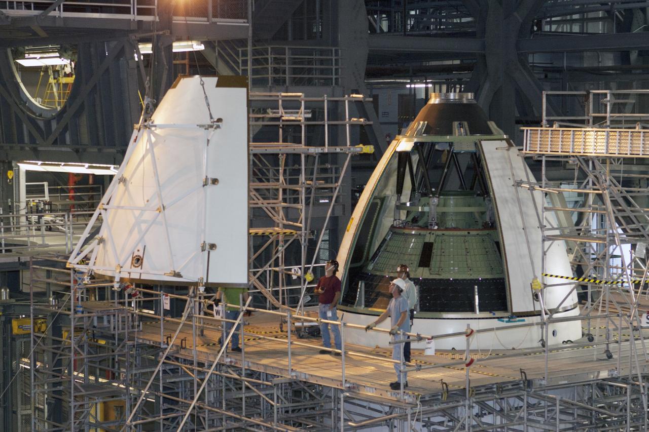 CAPE CANAVERAL, Fla. – At NASA’s Kennedy Space Center in Florida, technicians monitor the progress as a crane is used to move an ogive panel closer for installation on the Orion ground test vehicle in Vehicle Assembly Building high bay 4. The ogive panels enclose the Orion spacecraft and attach to the Launch Abort System. The test vehicle is being used Ground Systems Development and Operations Program for path finding operations, including simulated manufacturing, assembly and stacking procedures. Orion is the exploration spacecraft designed to carry astronauts to destinations not yet explored by humans, including an asteroid and Mars. It will have emergency abort capability, sustain the crew during space travel and provide safe re-entry from deep space return velocities. The first unpiloted test flight of Orion is scheduled to launch in 2014 atop a Delta IV rocket and in 2017 on NASA’s Space Launch System rocket. For more information, visit www.nasa.gov/orion. Photo credit: Kim Shiflett