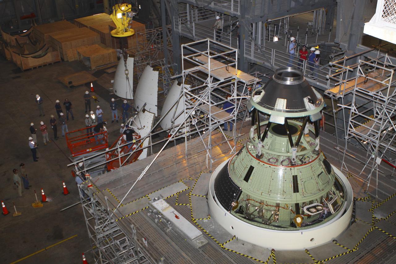 CAPE CANAVERAL, Fla. – At NASA’s Kennedy Space Center in Florida, technicians prepare the four ogive panels for lifting by crane so that they can be installed on the Orion ground test vehicle in Vehicle Assembly Building high bay 4. The ogive panels enclose and protect the Orion spacecraft and attach to the Launch Abort System. The test vehicle is being used by the Ground Systems Development and Operations Program for path finding operations, including simulated manufacturing, assembly and stacking procedures. Orion is the exploration spacecraft designed to carry astronauts to destinations not yet explored by humans, including an asteroid and Mars. It will have emergency abort capability, sustain the crew during space travel and provide safe re-entry from deep space return velocities. The first unpiloted test flight of Orion is scheduled to launch in 2014 atop a Delta IV rocket and in 2017 on NASA’s Space Launch System rocket. For more information, visit www.nasa.gov/orion. Photo credit: Kim Shiflett