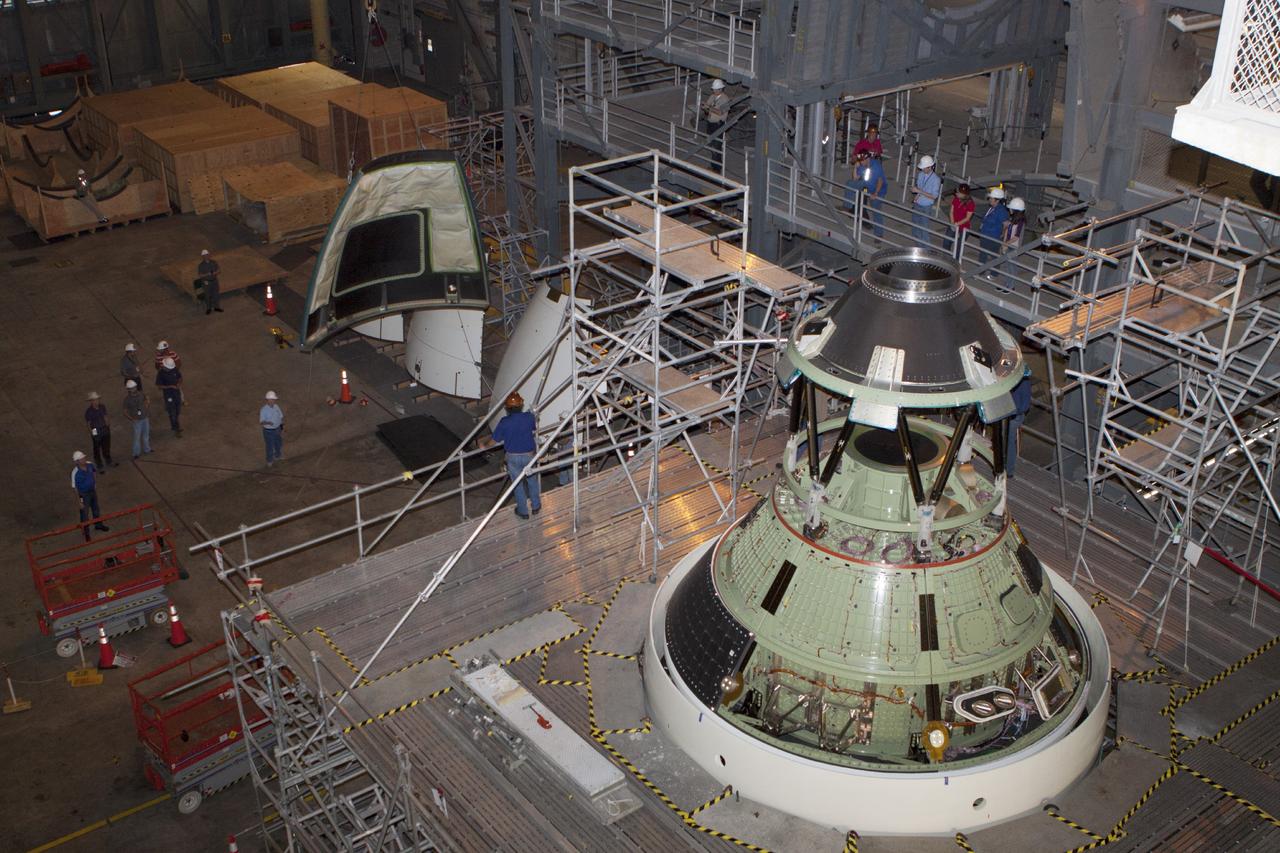 CAPE CANAVERAL, Fla. – At NASA’s Kennedy Space Center in Florida, technicians monitor the progress as a crane is used to move one of four ogive panels closer for installation on the Orion ground test vehicle in Vehicle Assembly Building high bay 4. The ogive panels enclose and protect the Orion spacecraft and attach to the Launch Abort System. The test vehicle is being used by the Ground Systems Development and Operations Program for path finding operations, including simulated manufacturing, assembly and stacking procedures. Orion is the exploration spacecraft designed to carry astronauts to destinations not yet explored by humans, including an asteroid and Mars. It will have emergency abort capability, sustain the crew during space travel and provide safe re-entry from deep space return velocities. The first unpiloted test flight of Orion is scheduled to launch in 2014 atop a Delta IV rocket and in 2017 on NASA’s Space Launch System rocket. For more information, visit www.nasa.gov/orion. Photo credit: Kim Shiflett